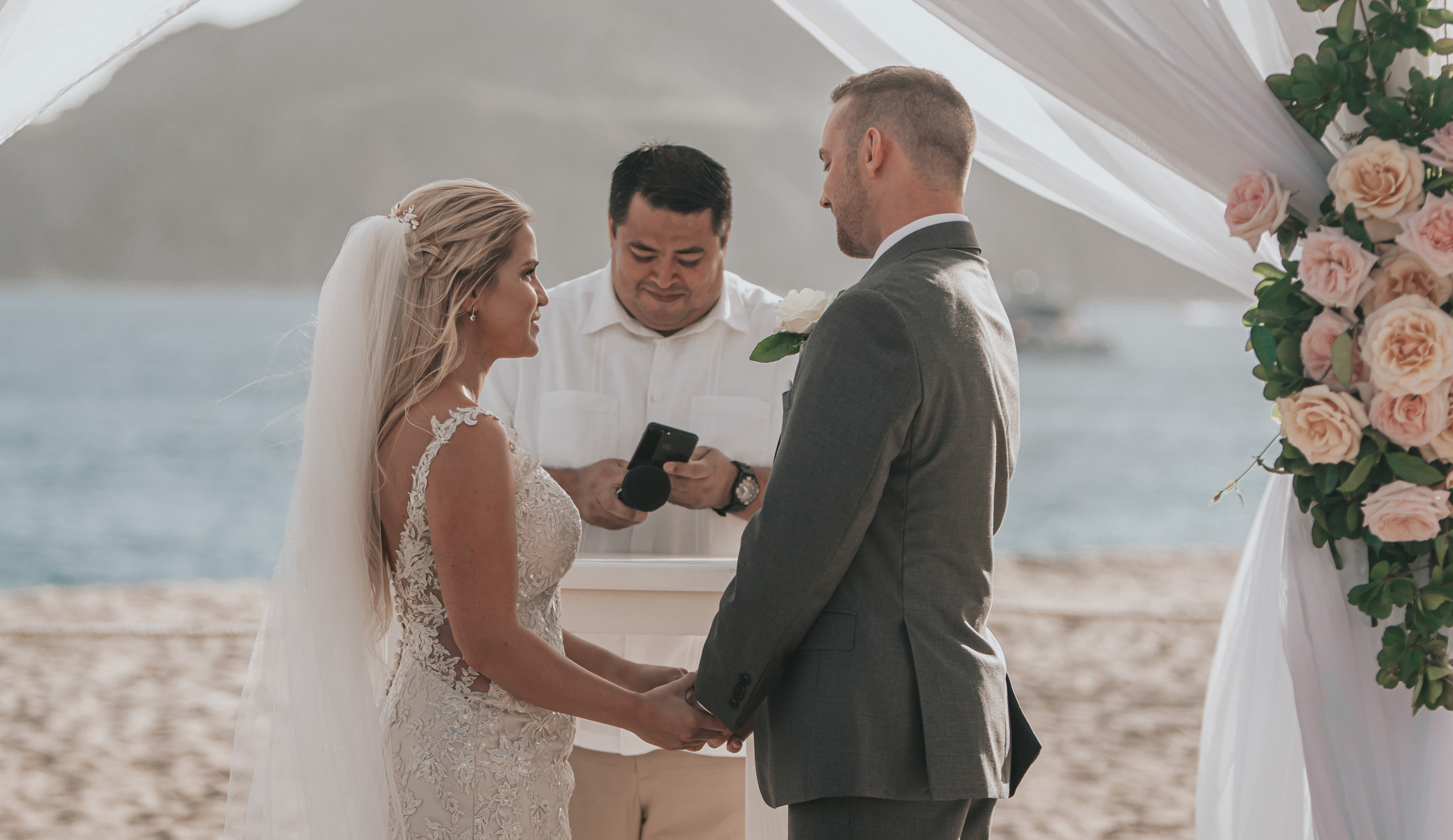 Bride and groom exchanging rings at luxury resort in Cabo