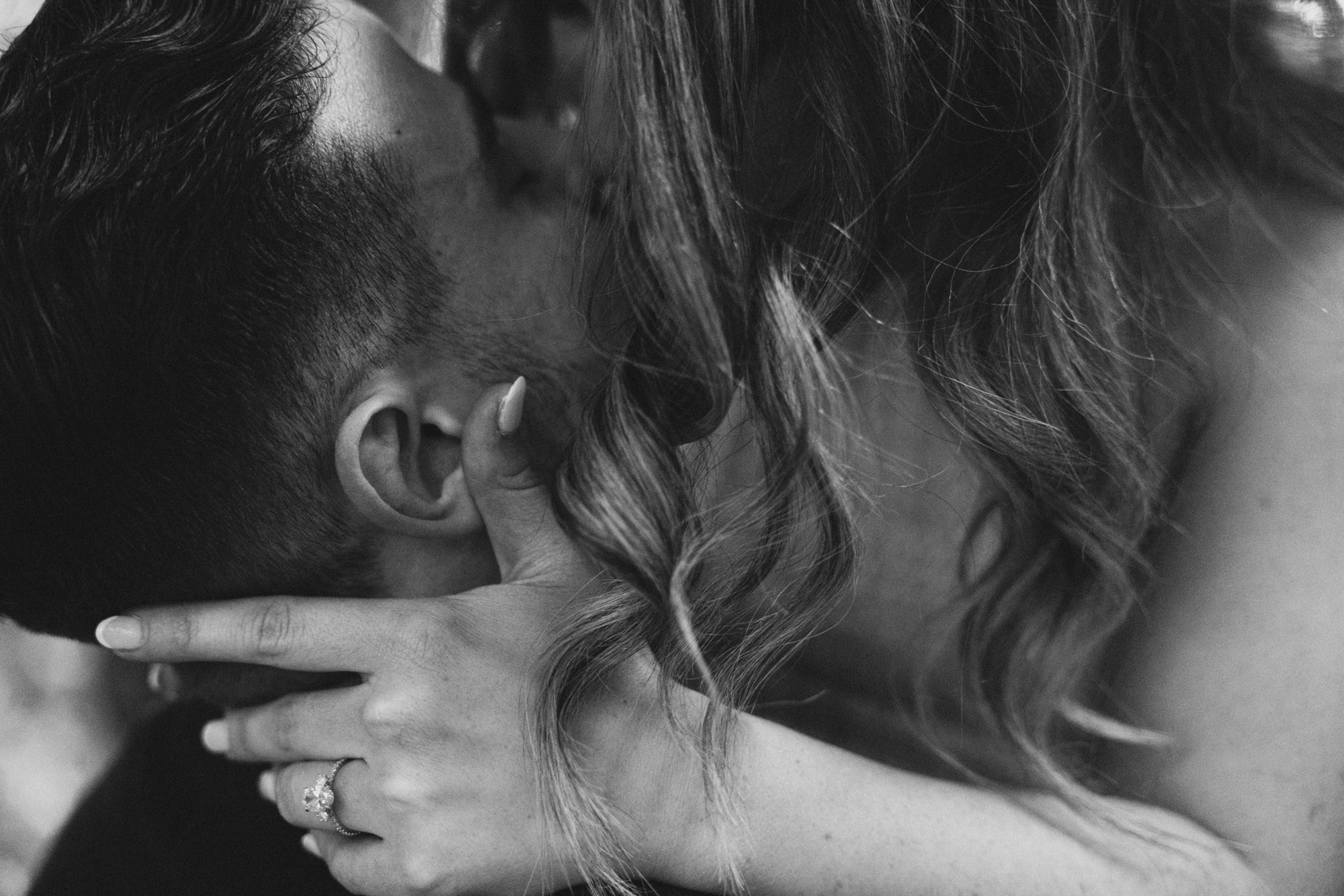 Black-and-white close-up of a couple kissing