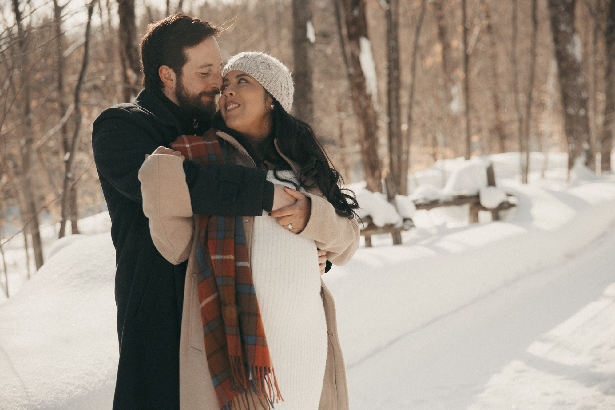 Expecting couple embracing during a winter maternity session in Montreal