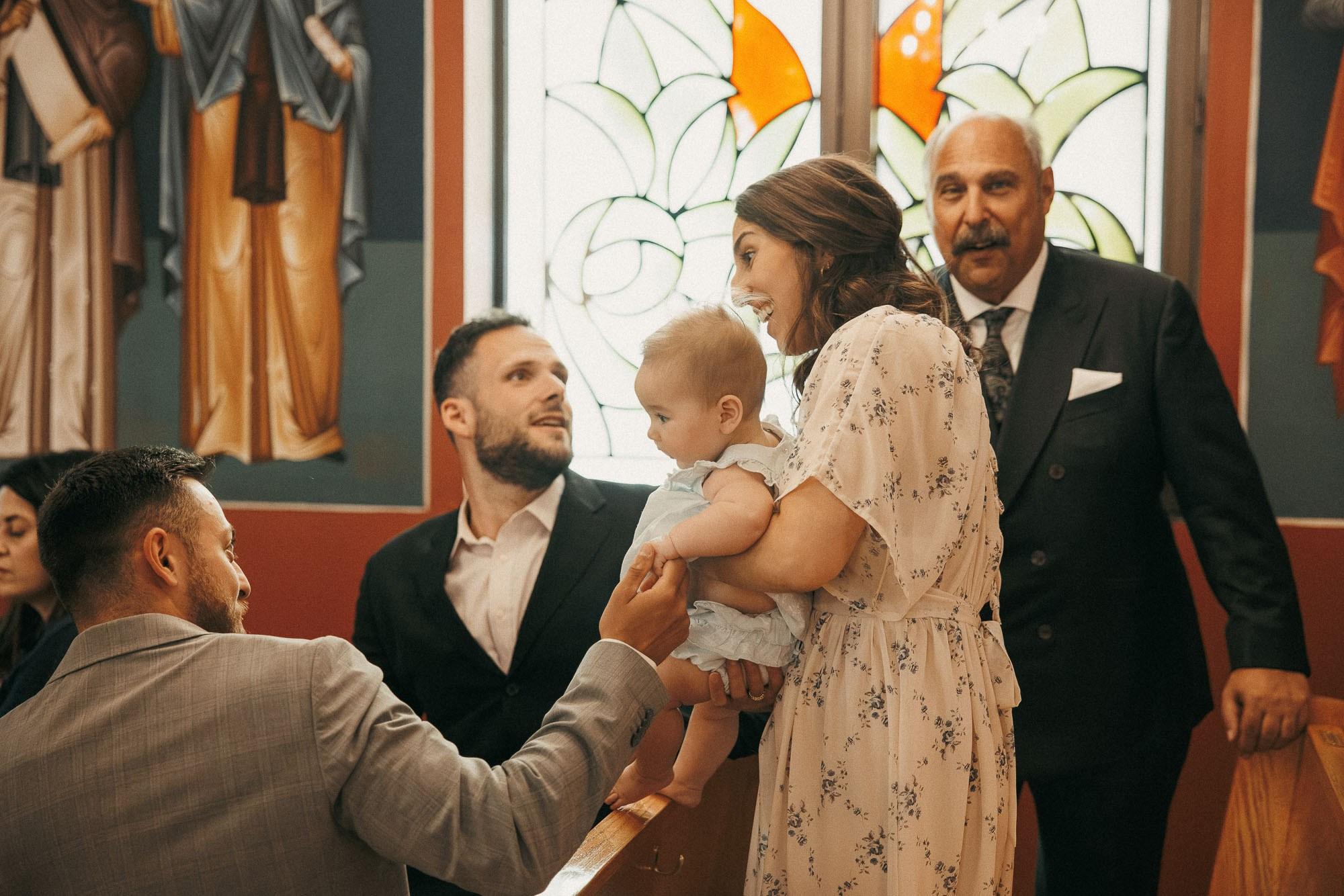 Family members greet a baby inside the church before the ceremony.