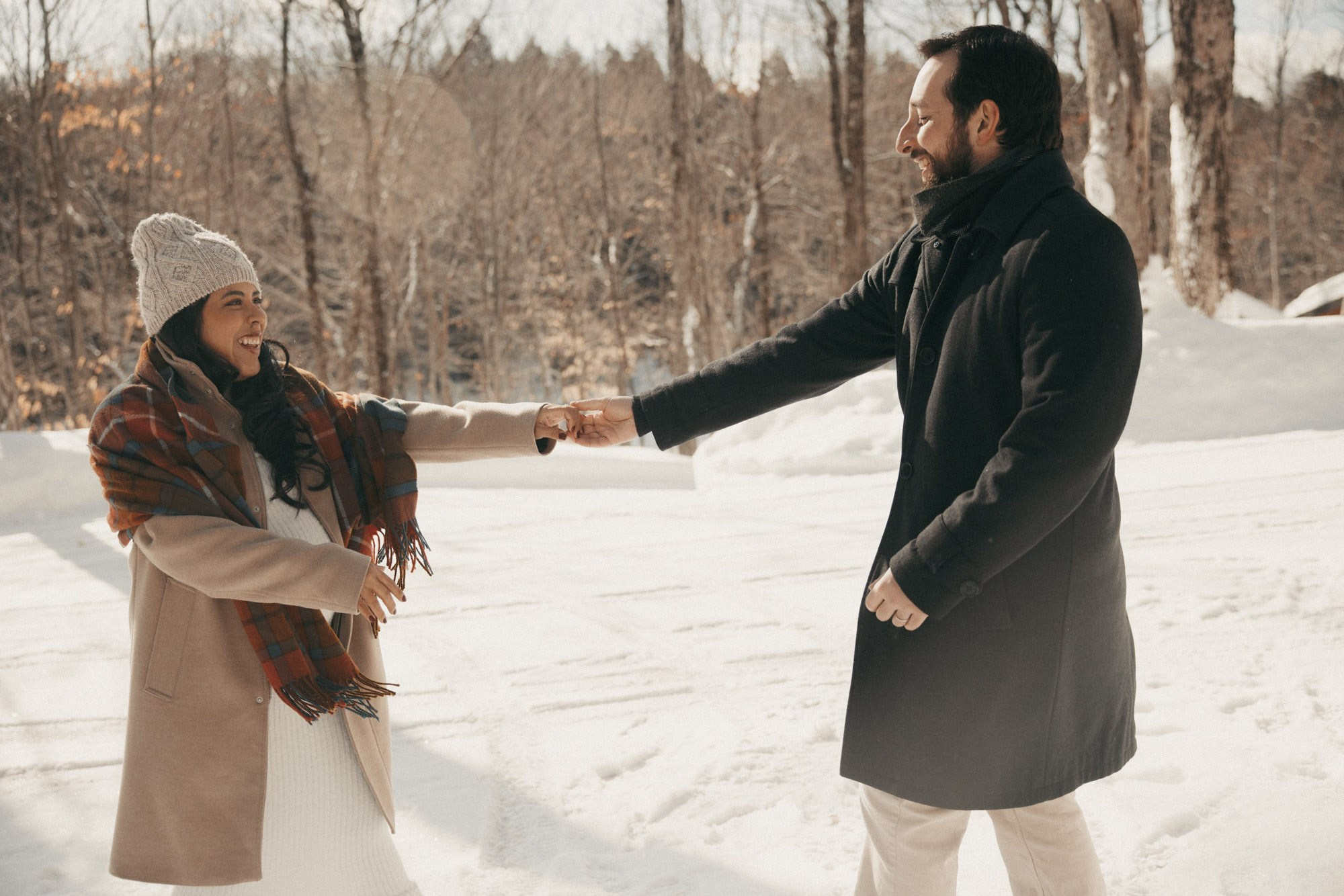 Expecting couple holding hands during a winter maternity session in Montreal