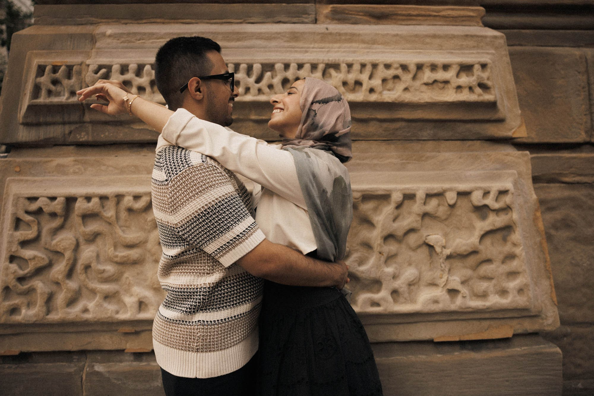 Man lifting his partner in front of an ornate stone building in Montreal
