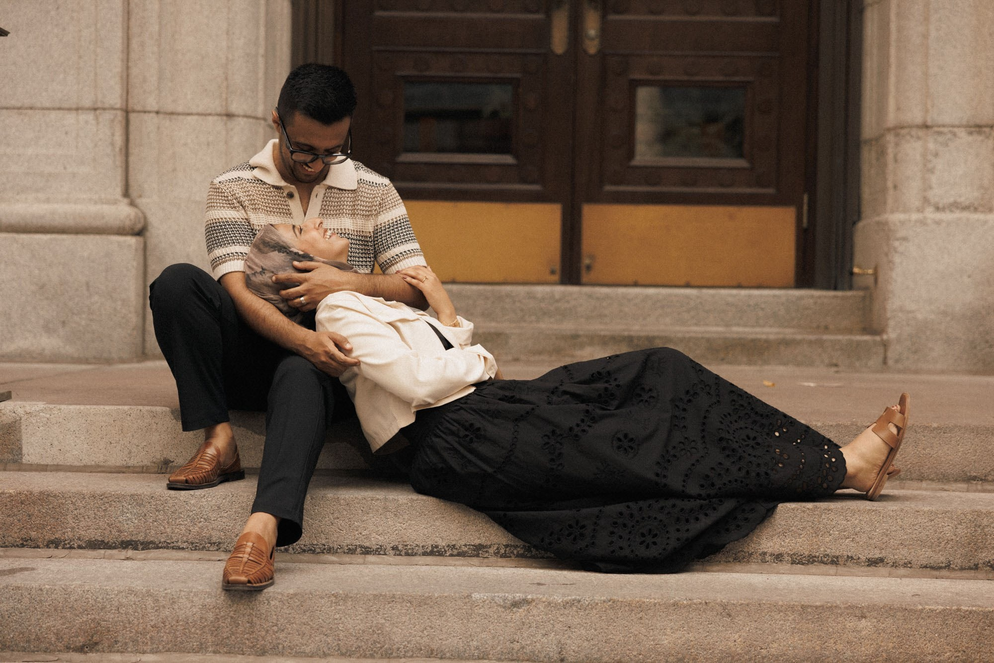 Couple sharing a quiet moment on stone steps in Old Montreal