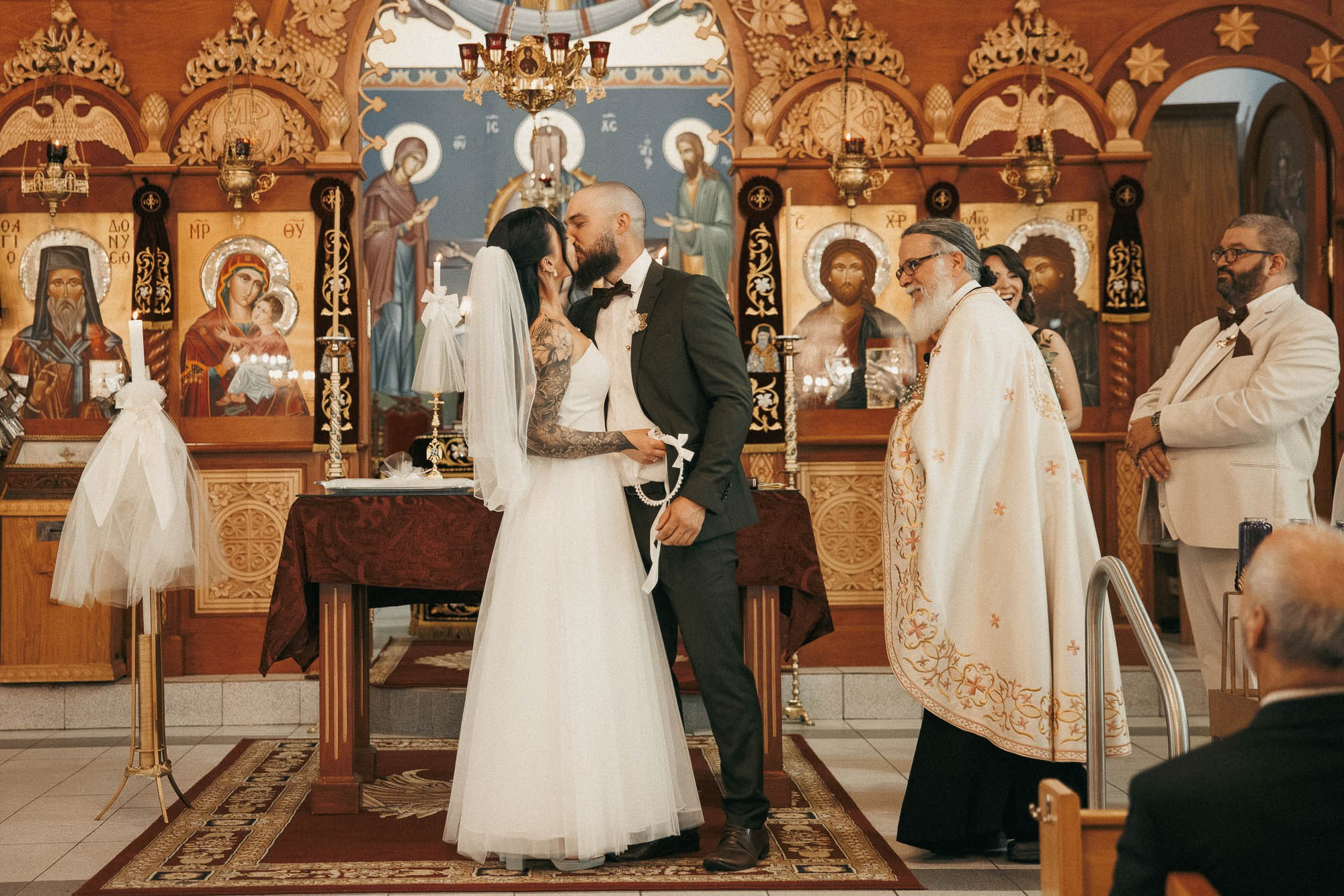 Kendyl and Mikey kiss at the altar after their wedding ceremony.