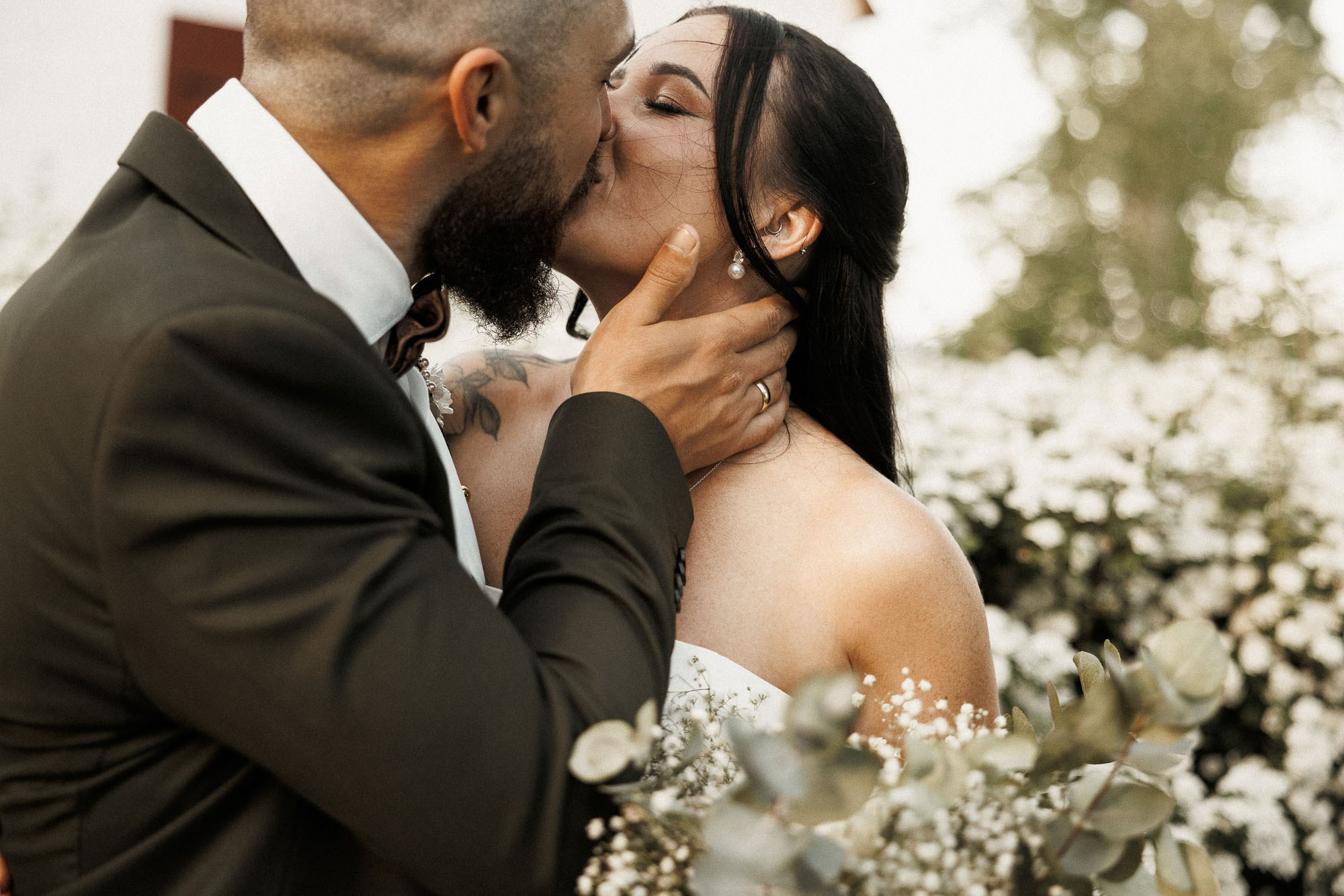 Mikey kisses Kendyl during their intimate outdoor wedding portraits.