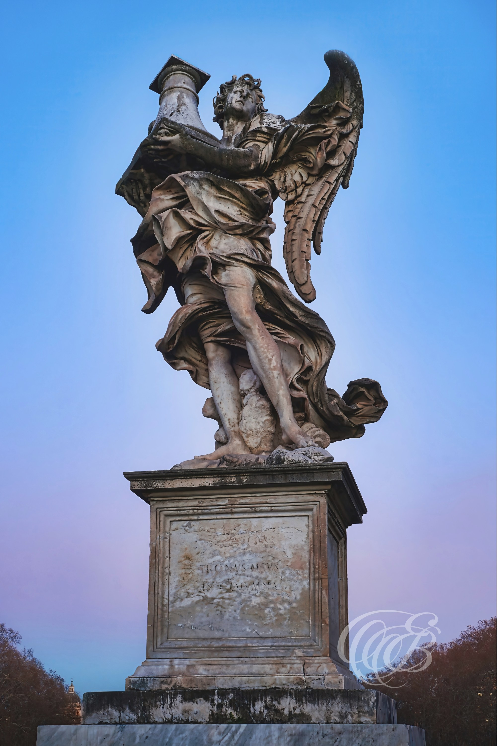 ITALY TRAVEL PHOTOGRAPHY – ITALY – ROME — Ponte Sant’Angelo Angel with Column — Baroque angel sculpture carrying a column on Ponte Sant’Angelo, part of the series designed under the direction of Gian Lorenzo Bernini, Rome, Italy — Eduardo Bartoli Photography.
