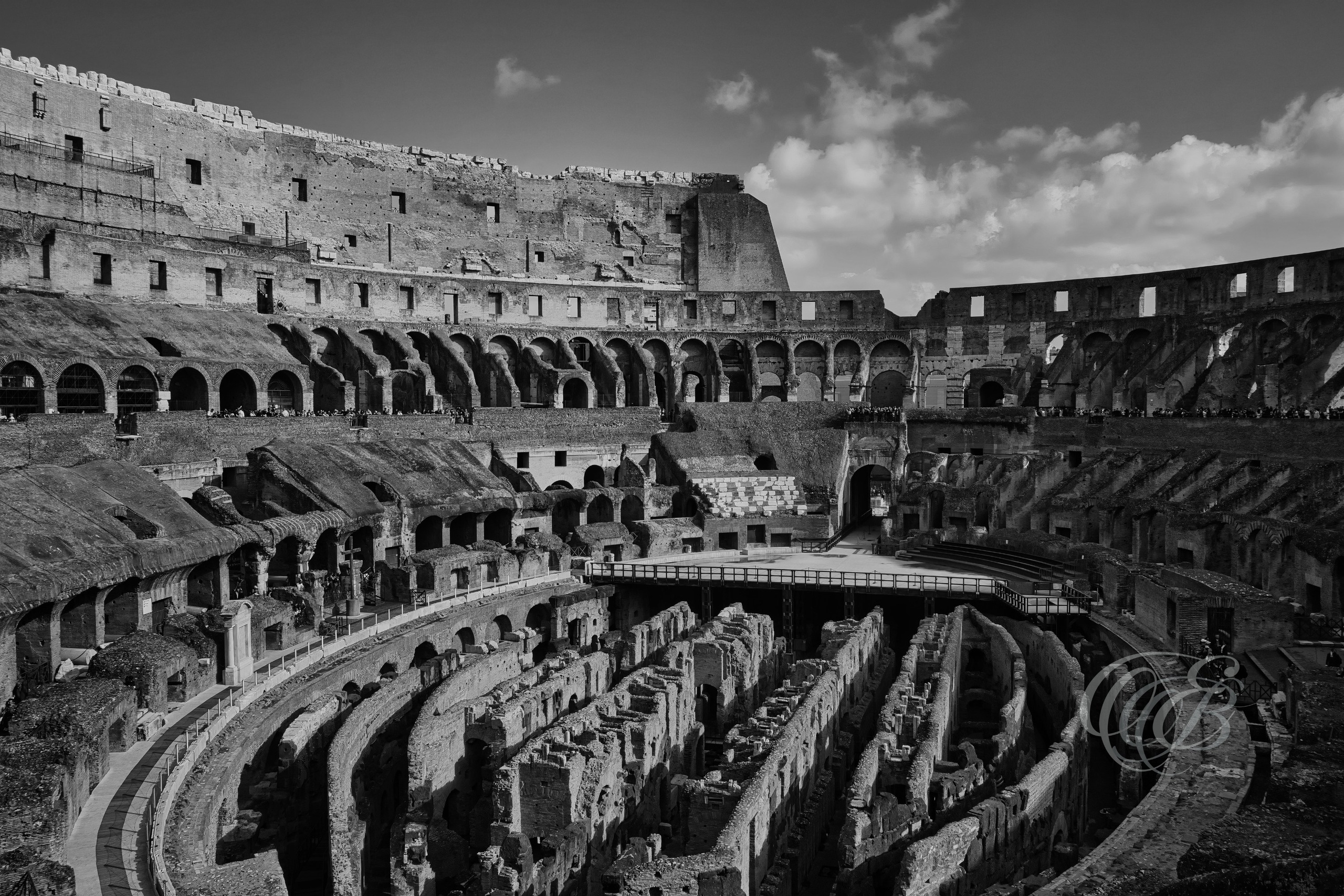 Rome Italy – Colosseum under the summer light, ancient Roman amphitheater revealing weathered stone and layered arches in black and white fine art photography. Rome, Italy – photography by Eduardo Bartoli.