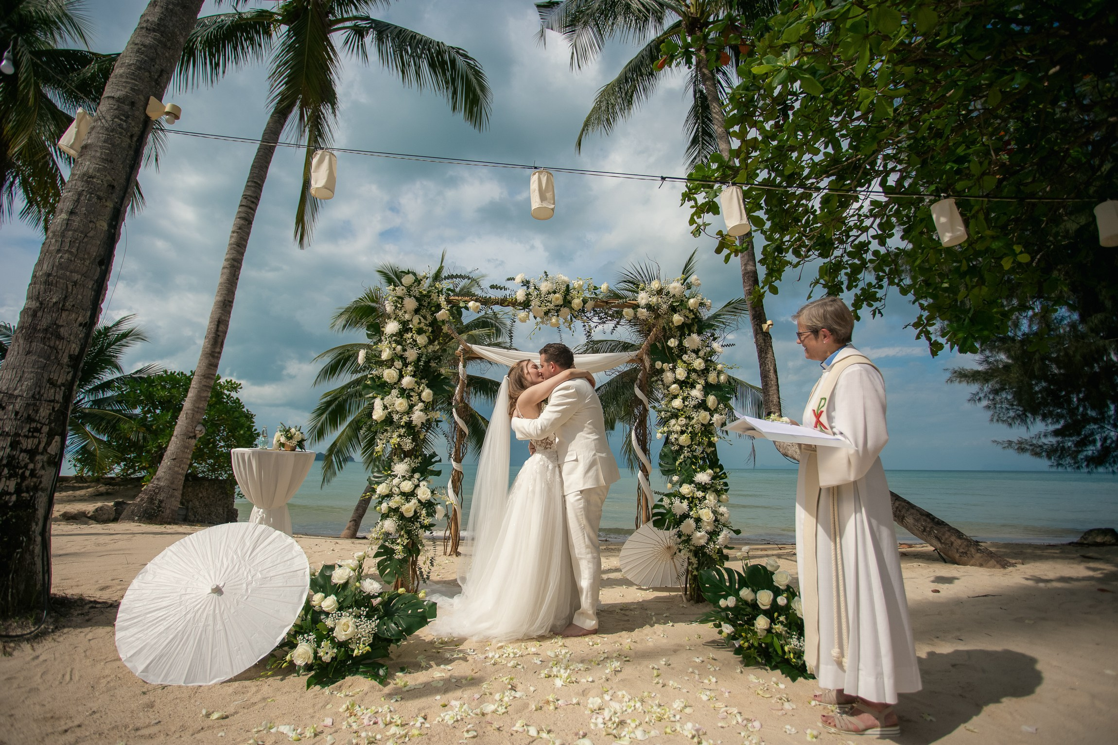 Couple celebrating a private destination wedding for two on a sandy beach in Koh Samui, Thailand