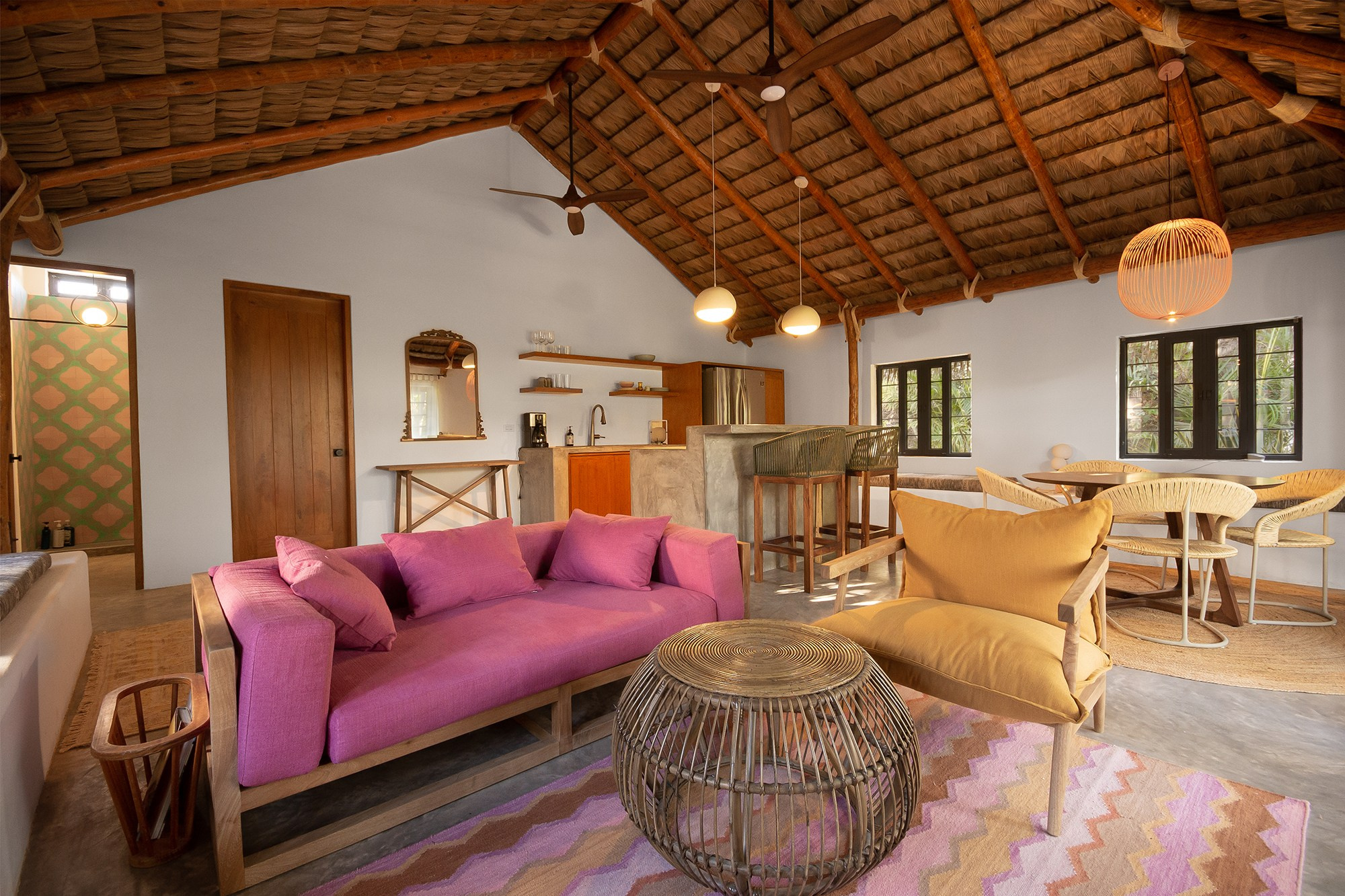 Open living space in Los Cabos home – warm lighting with living room, dining and kitchen in one area, modern real estate photography