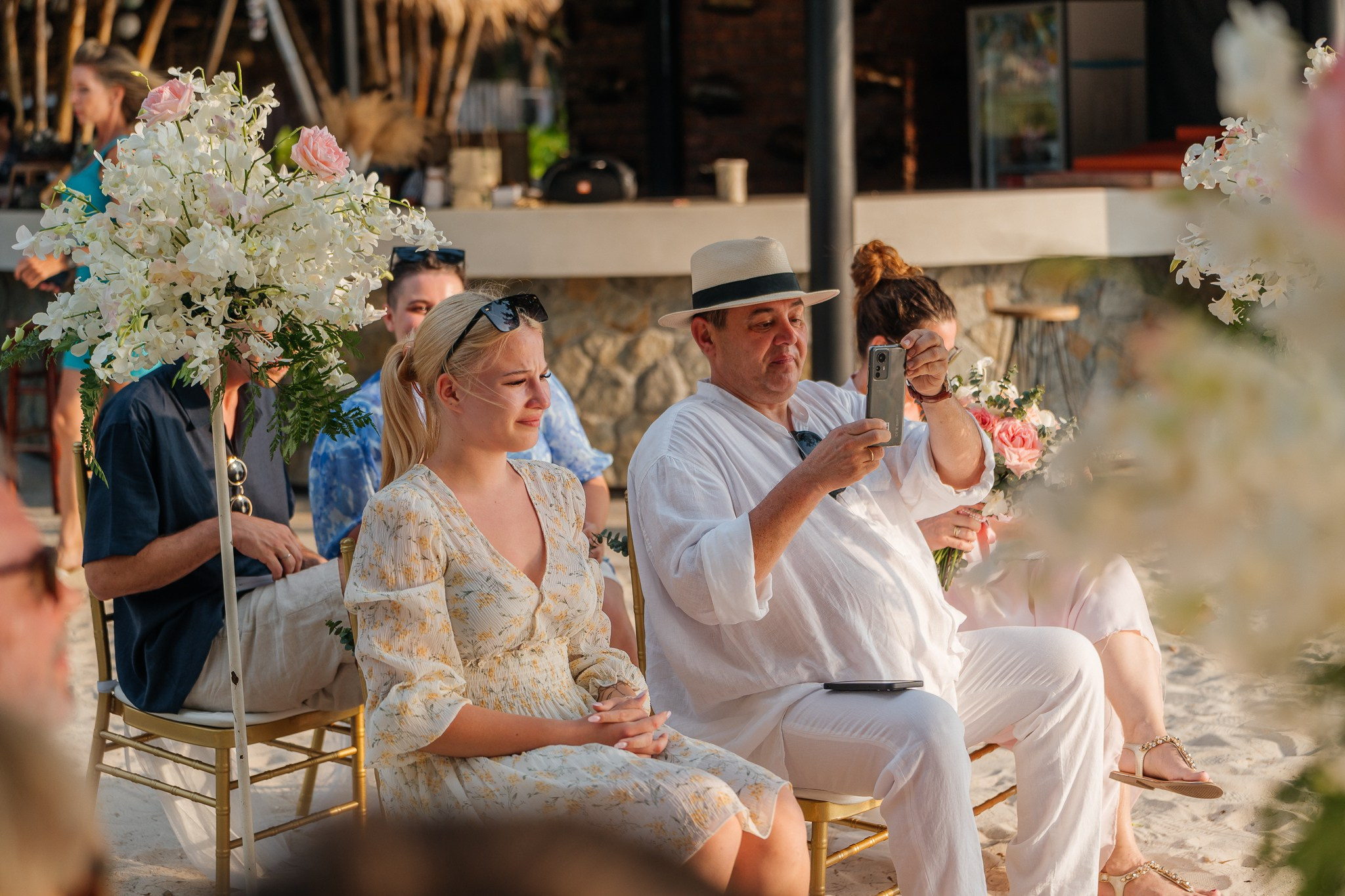 Destination beach wedding in Koh Samui, Thailand with the couple, family members and friends enjoying a tropical wedding ceremony by the sea