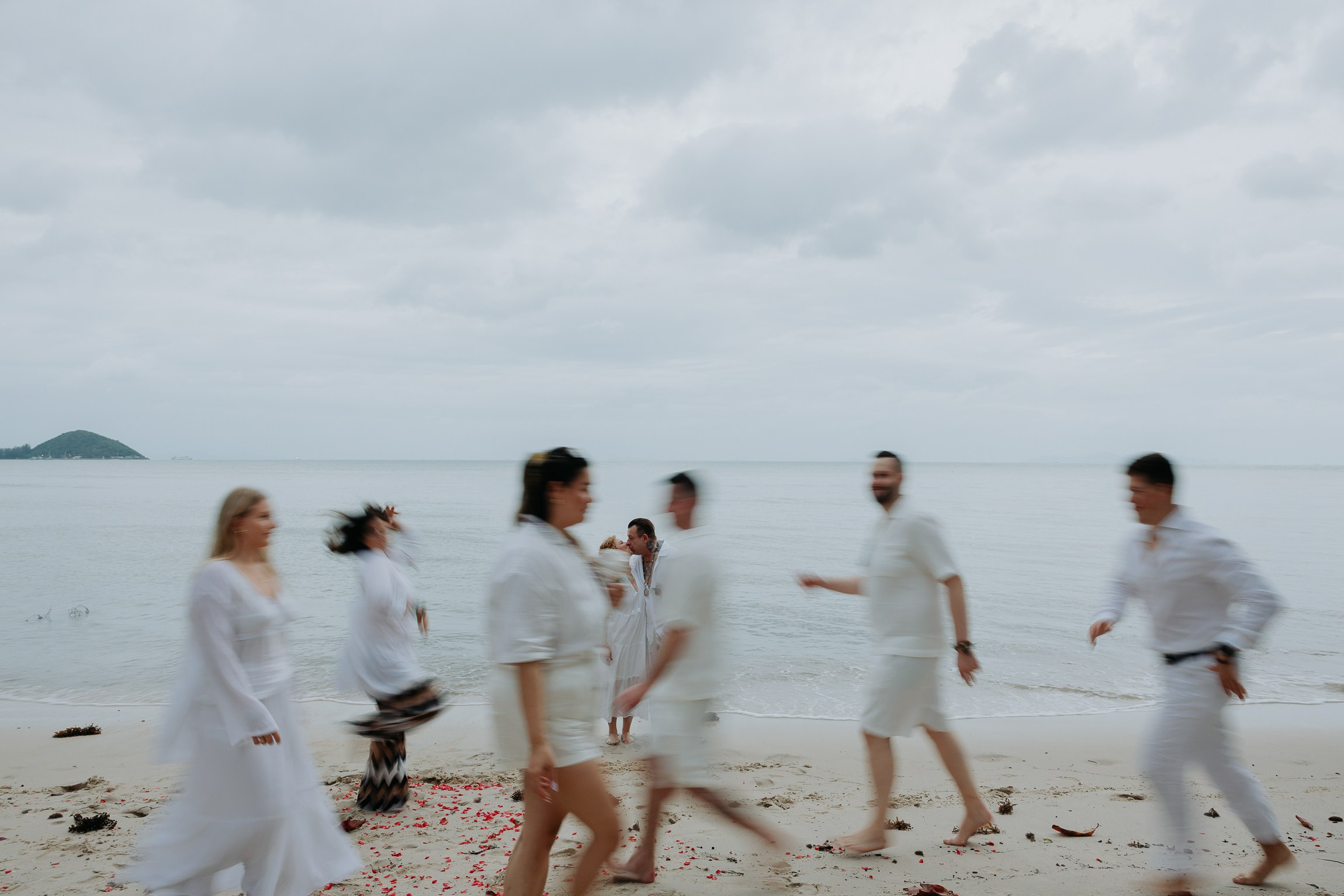 Couple with guests celebrating a spiritual Buddhist wedding ceremony on Koh Samui
