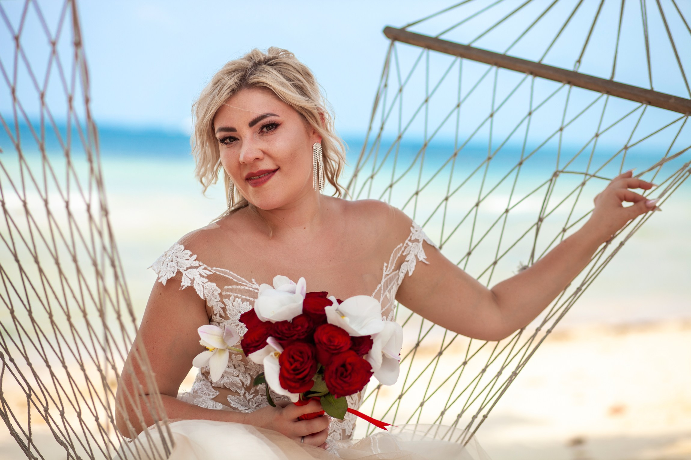 Elegant beach wedding setup on Koh Samui, Thailand with bride, groom, flowers and stunning sea backdrop