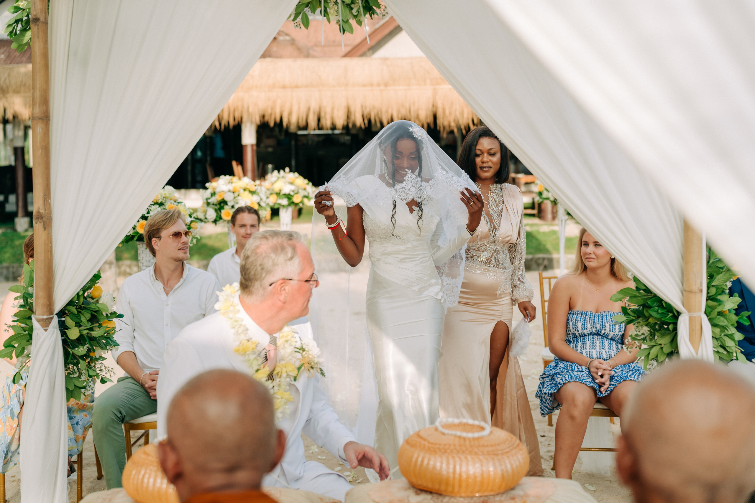 Couple receiving a traditional Buddhist wedding blessing from Thai monks in Koh Samui