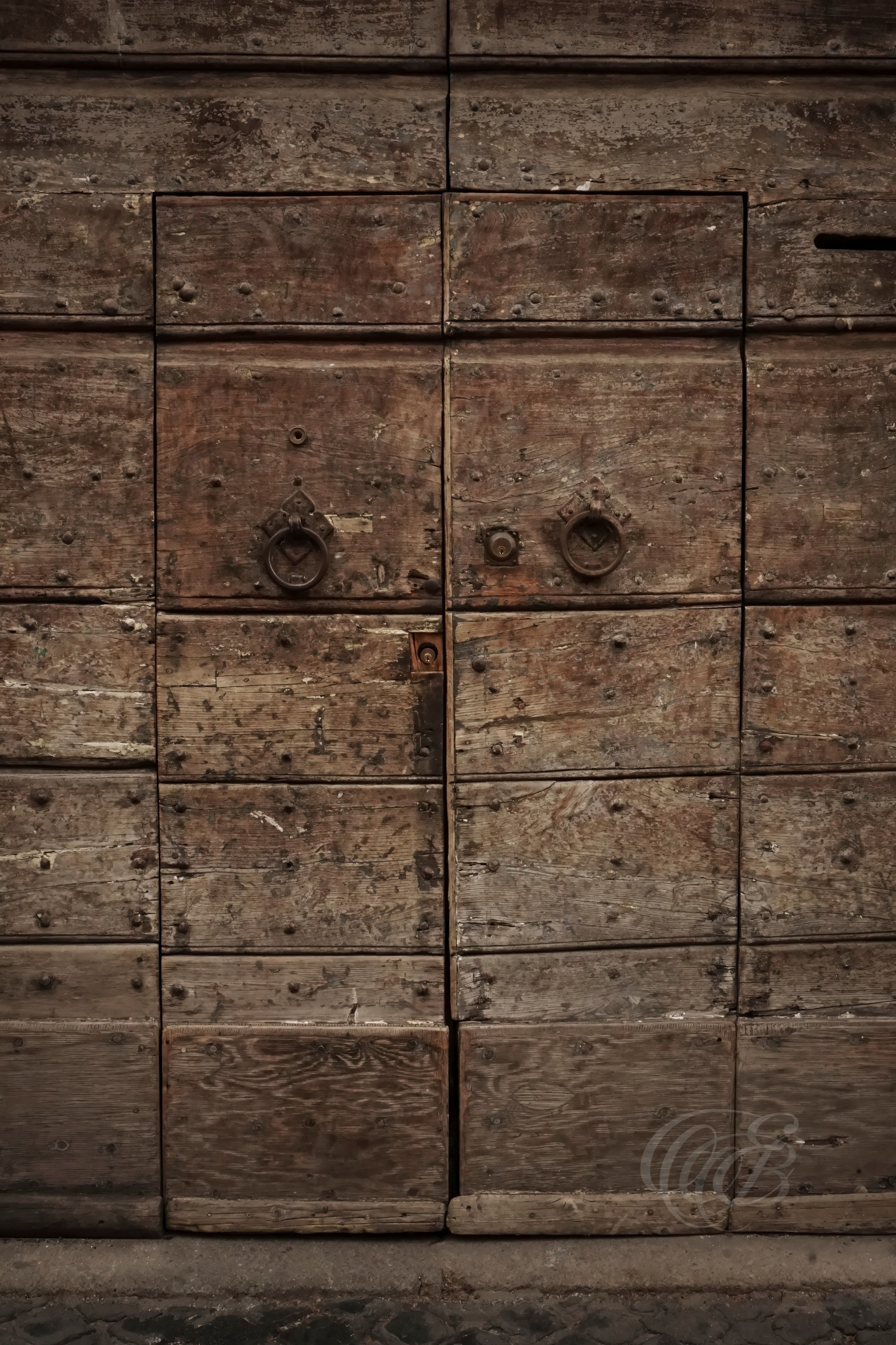 Street Photography — Rome, Italy — Rustic Old Door — Rustic doorway in Rome with aged materials, weathered textures, and traditional craftsmanship, reflecting the enduring architectural character of the city’s older streets — Eduardo Bartoli Photography.