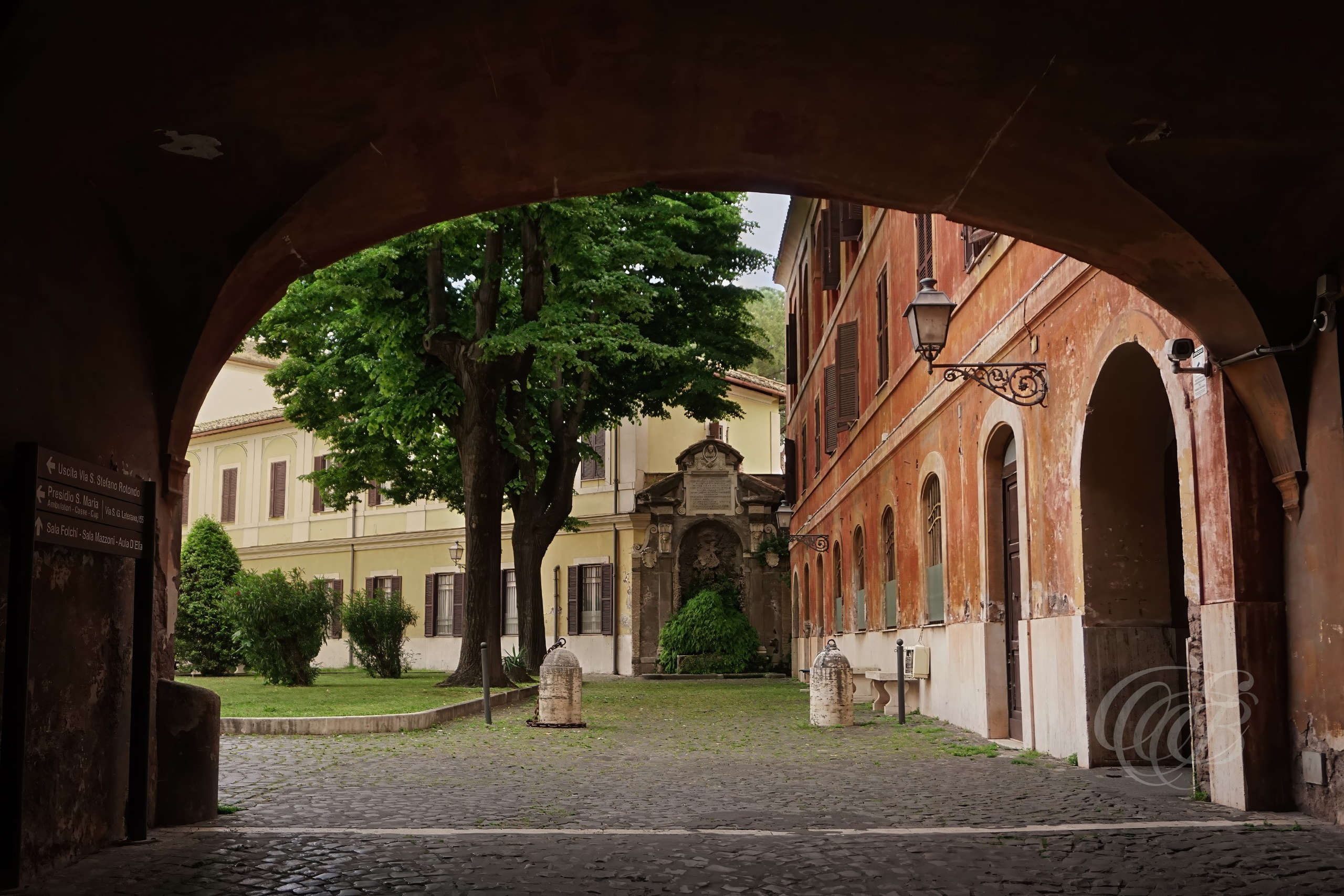 Street Photography — Rome, Italy — San Giovanni Hospital Archway — Historic archway within Rome’s San Giovanni hospital complex, reflecting centuries of architectural development and the longstanding institutional heritage of the Lateran area — Eduardo Bartoli Photography.