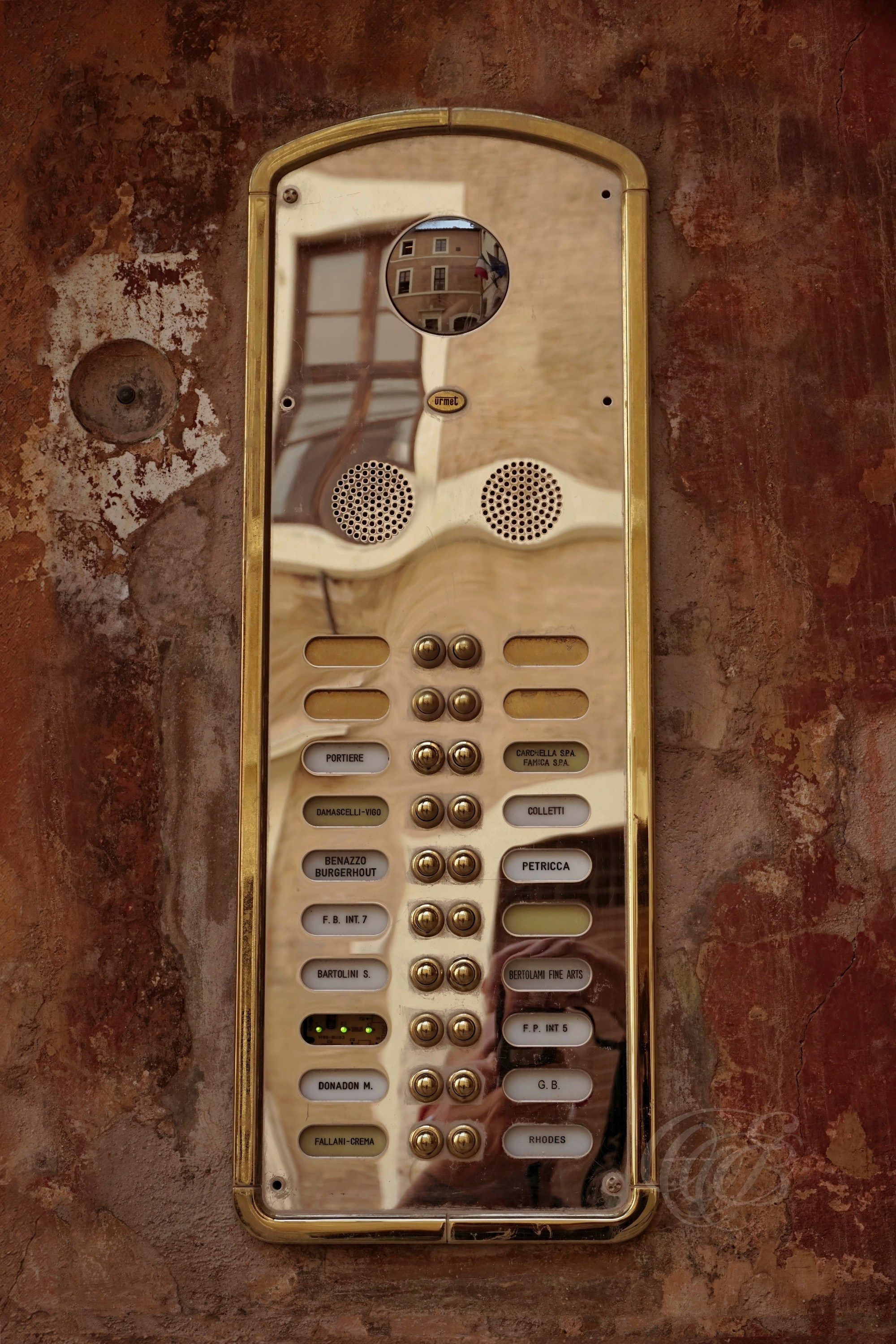 Street Photography — Rome, Italy — Golden Citofono — Golden intercom, known in Italian as a citofono, at a building entrance in Rome, combining an everyday element of Italian life with the architectural details of the city — Eduardo Bartoli Photography.