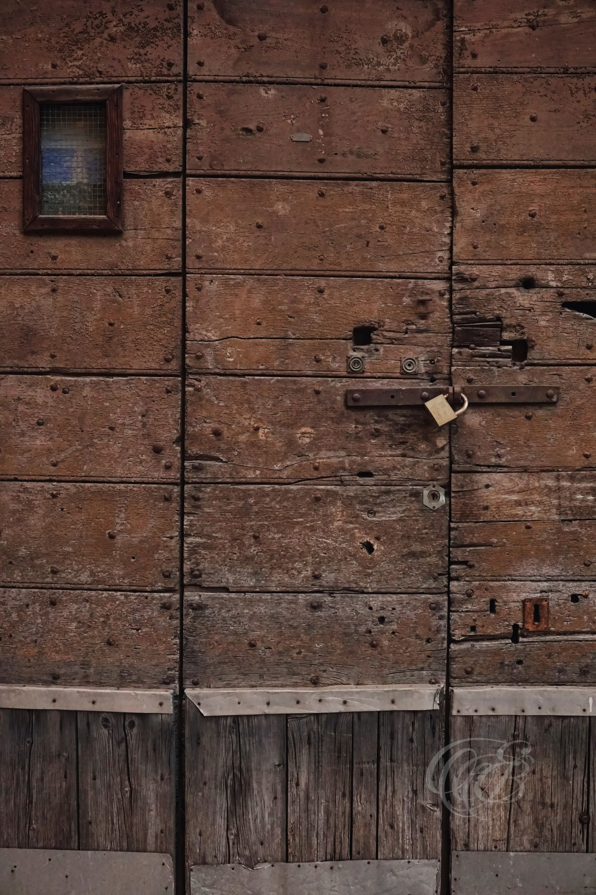 Street Photography — Rome, Italy — Old Reclaimed Wood Door — Door crafted from pieces of reclaimed old wood in Rome, preserving aged textures, natural imperfections, and traces of the material’s long history — Eduardo Bartoli Photography.