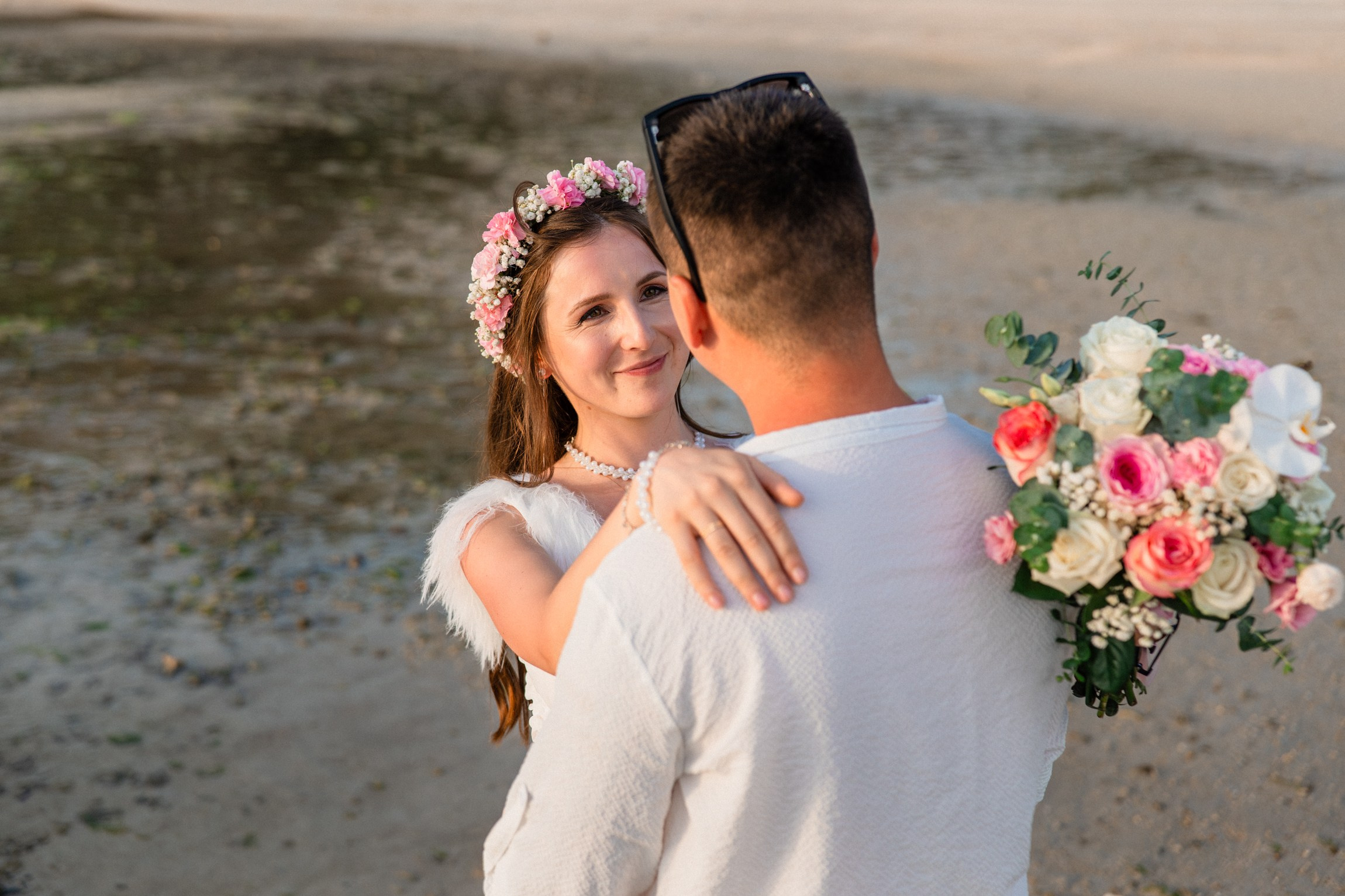 Bride and groom during a romantic beach wedding ceremony on Koh Samui, Thailand, surrounded by tropical scenery and ocean views