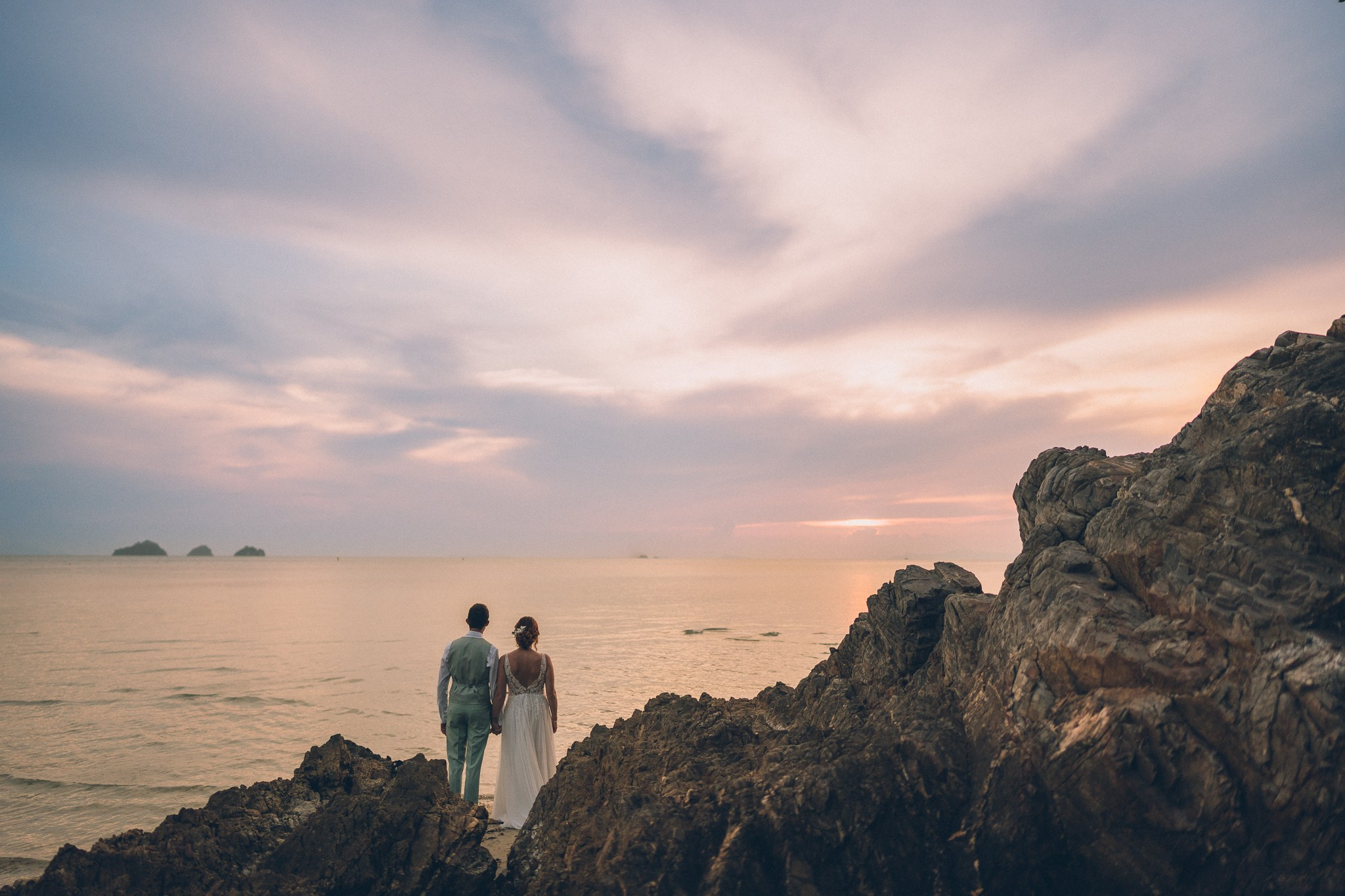 Wedding celebration with guests on a tropical sunset beach in Koh Samui