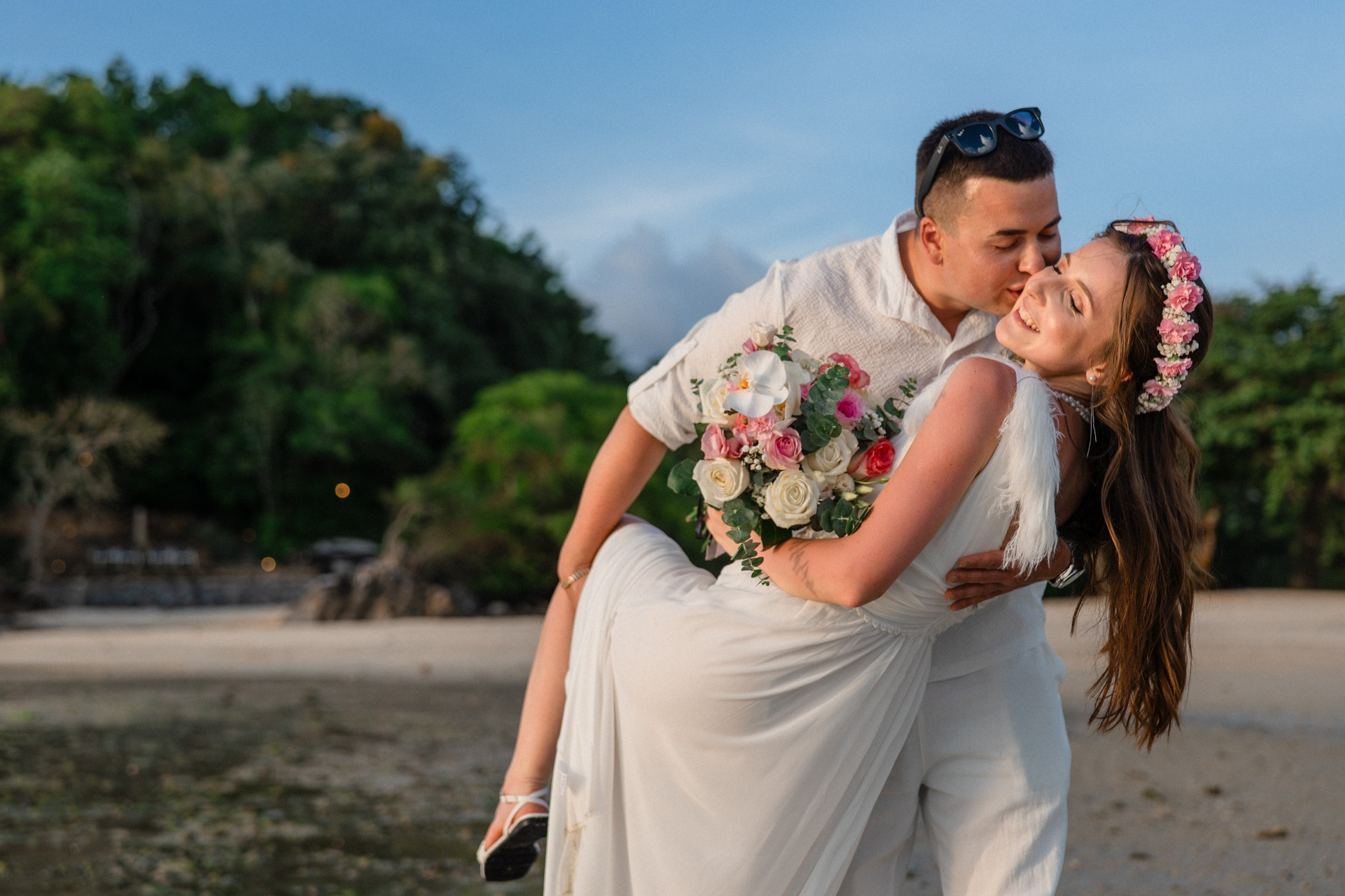 Bride and groom exchanging vows on a private sunset beach