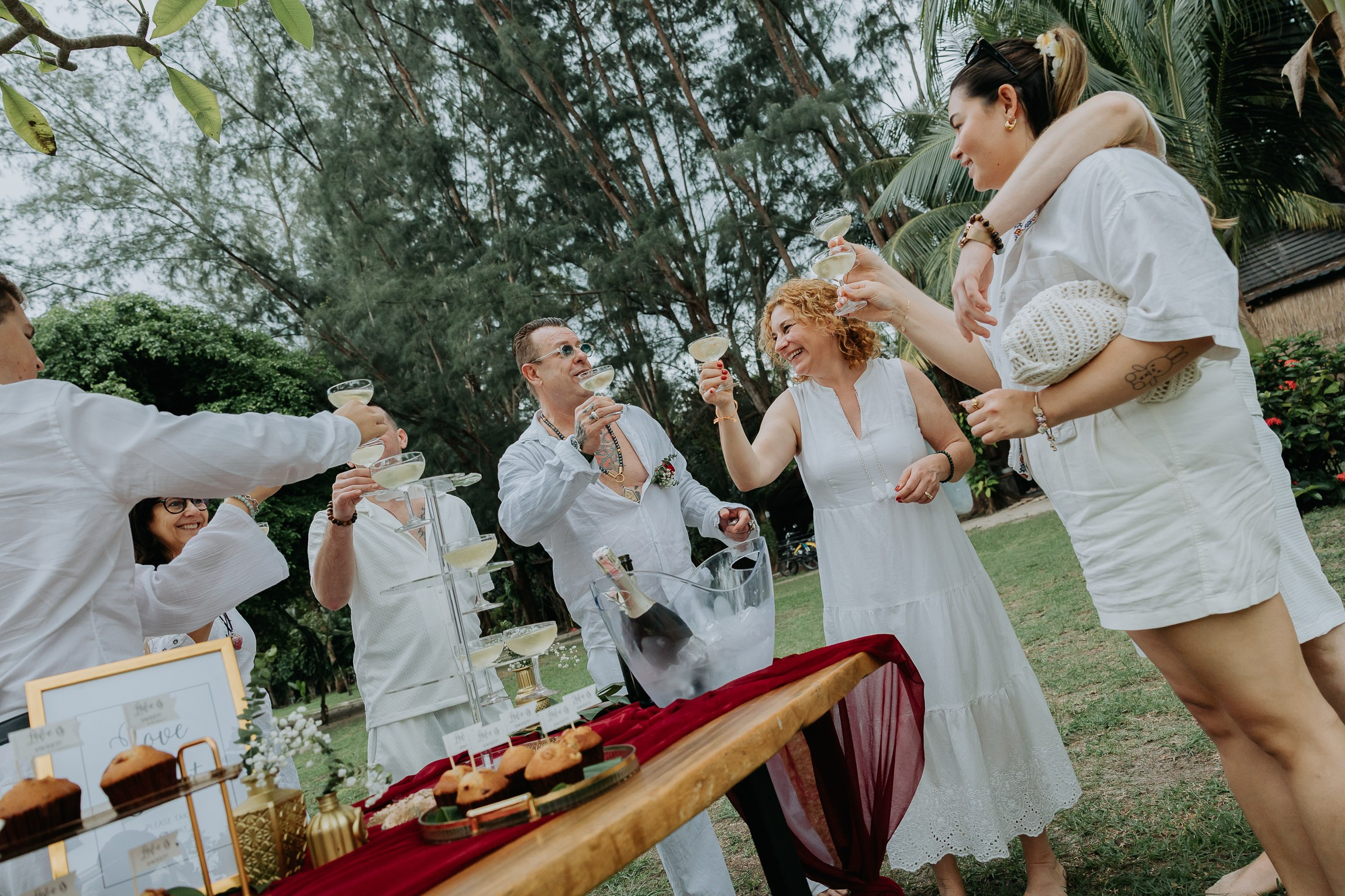 Bride and groom participating in a sacred Buddhist wedding blessing in Thailand