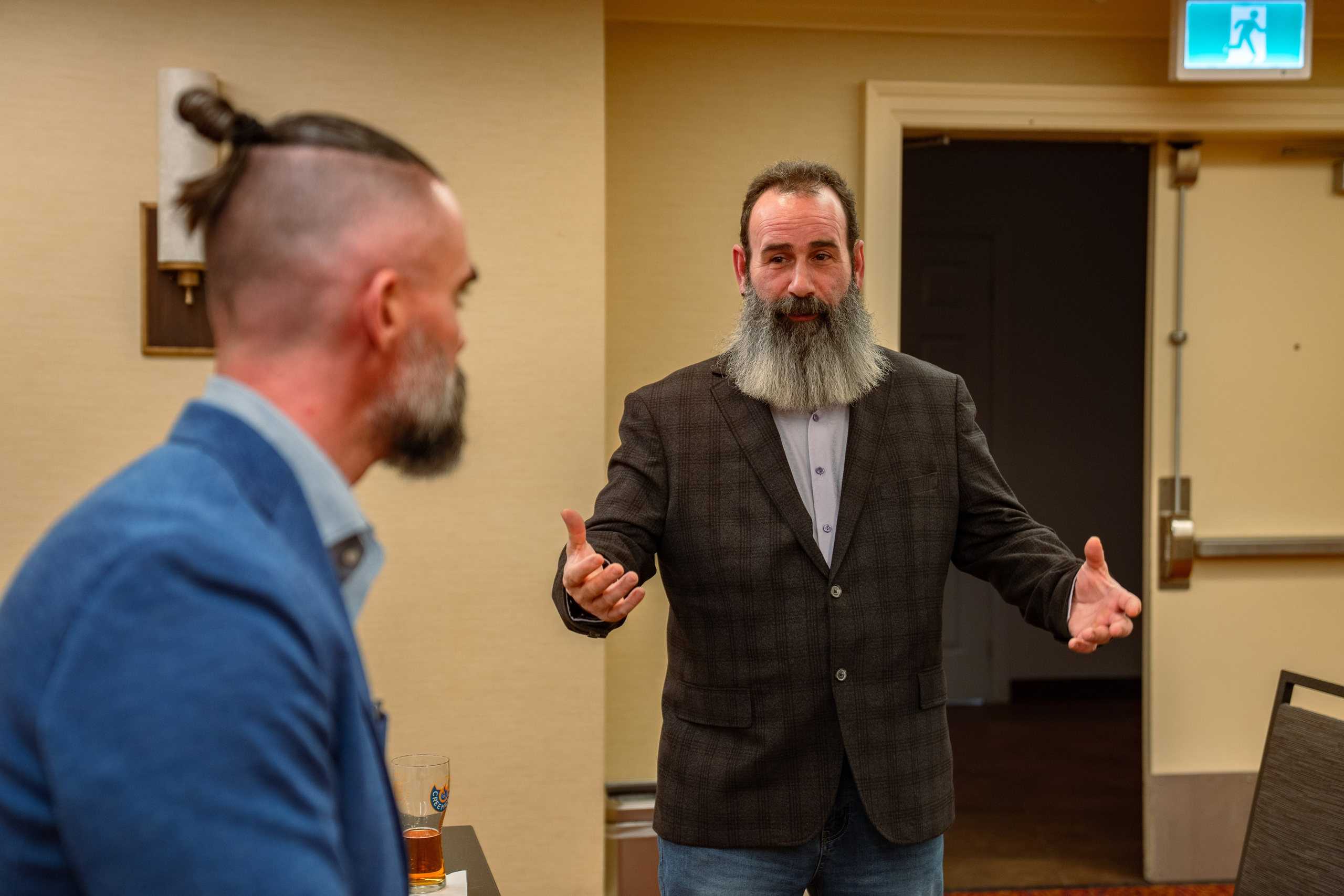 Matt Poechman speaking with attendee at networking event