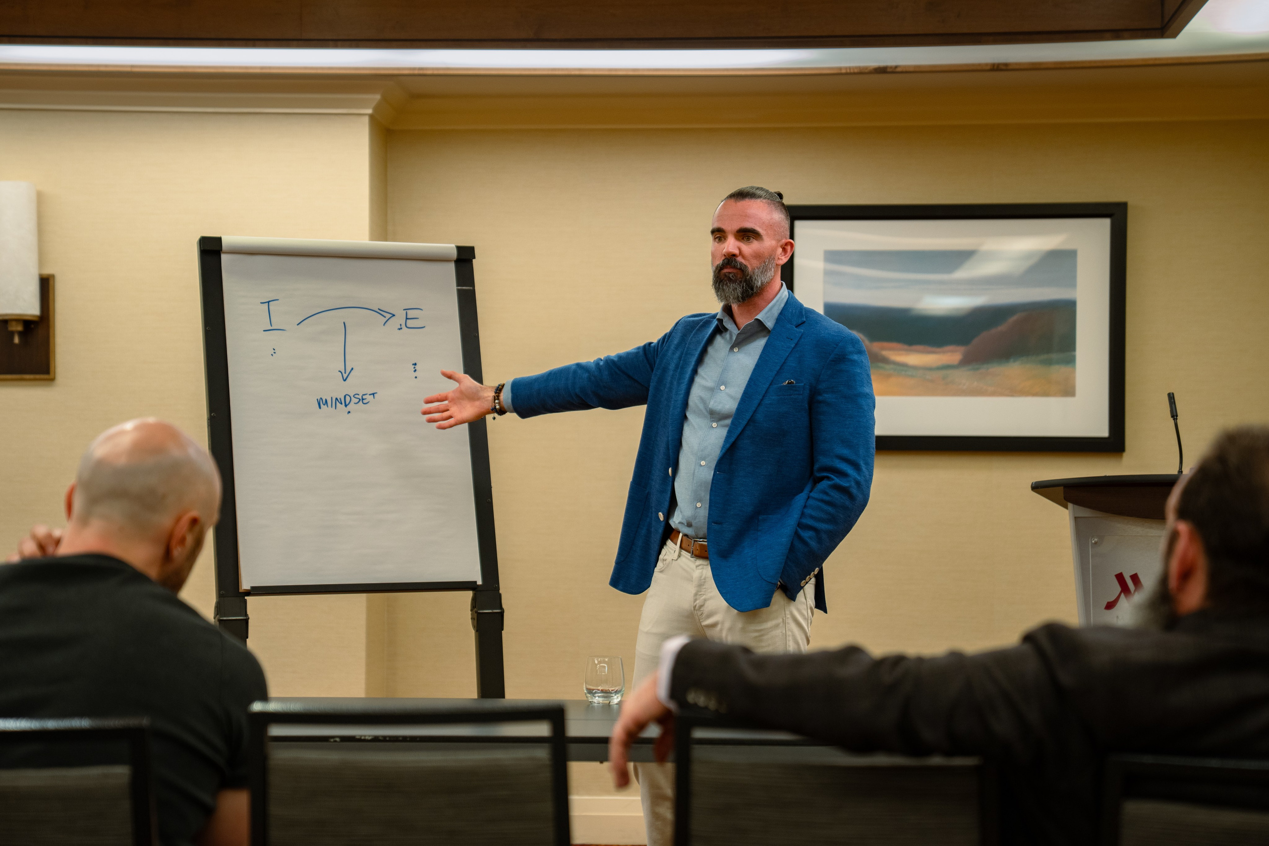 Matt Poechman presenting to seated attendees at networking event