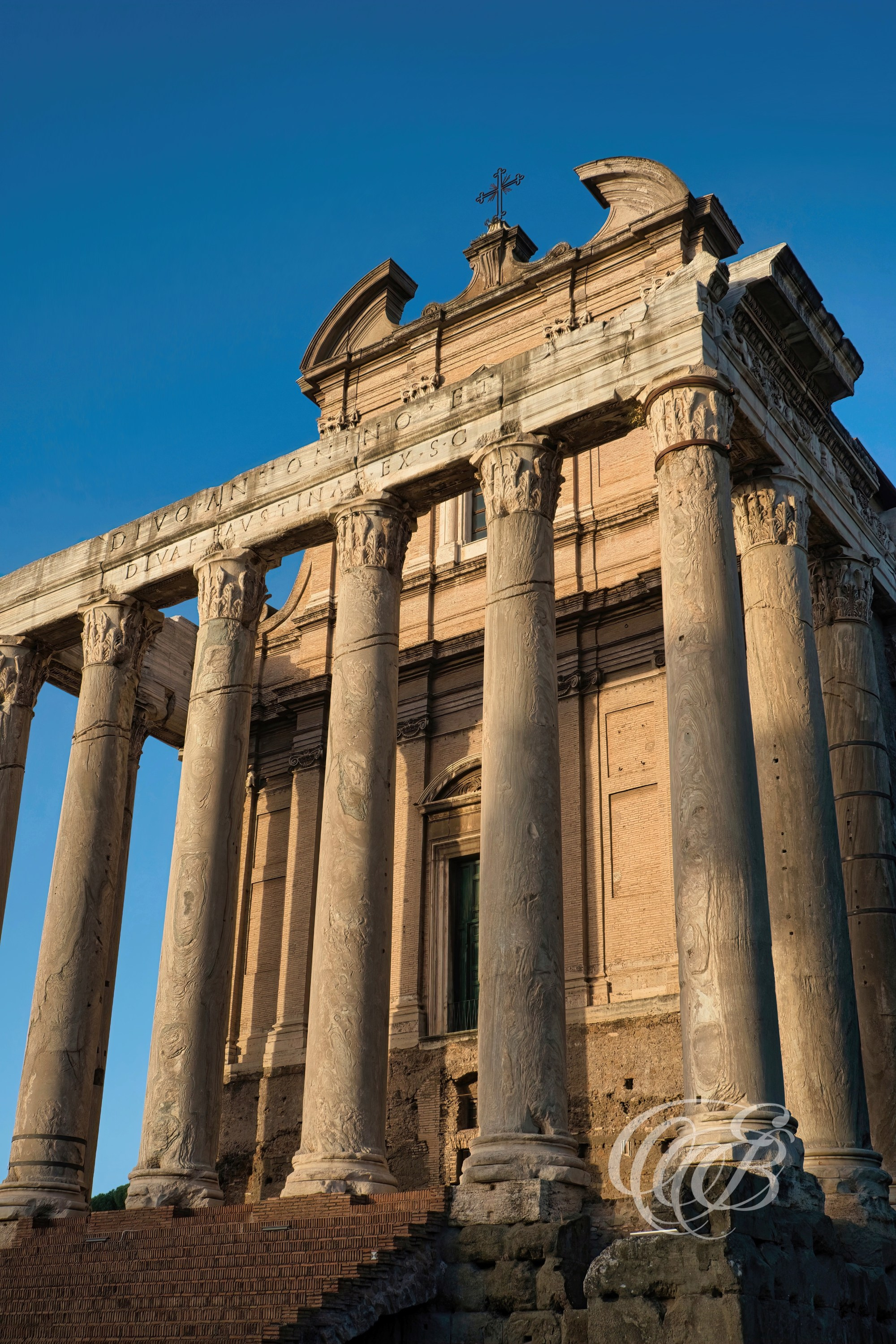ITALY TRAVEL PHOTOGRAPHY – ITALY – ROME — Temple of Antoninus and Faustina in the Roman Forum — Ancient Roman temple built in 141 AD with Corinthian columns, later converted into a church, located in the Roman Forum, Rome, Italy — Eduardo Bartoli Photography.