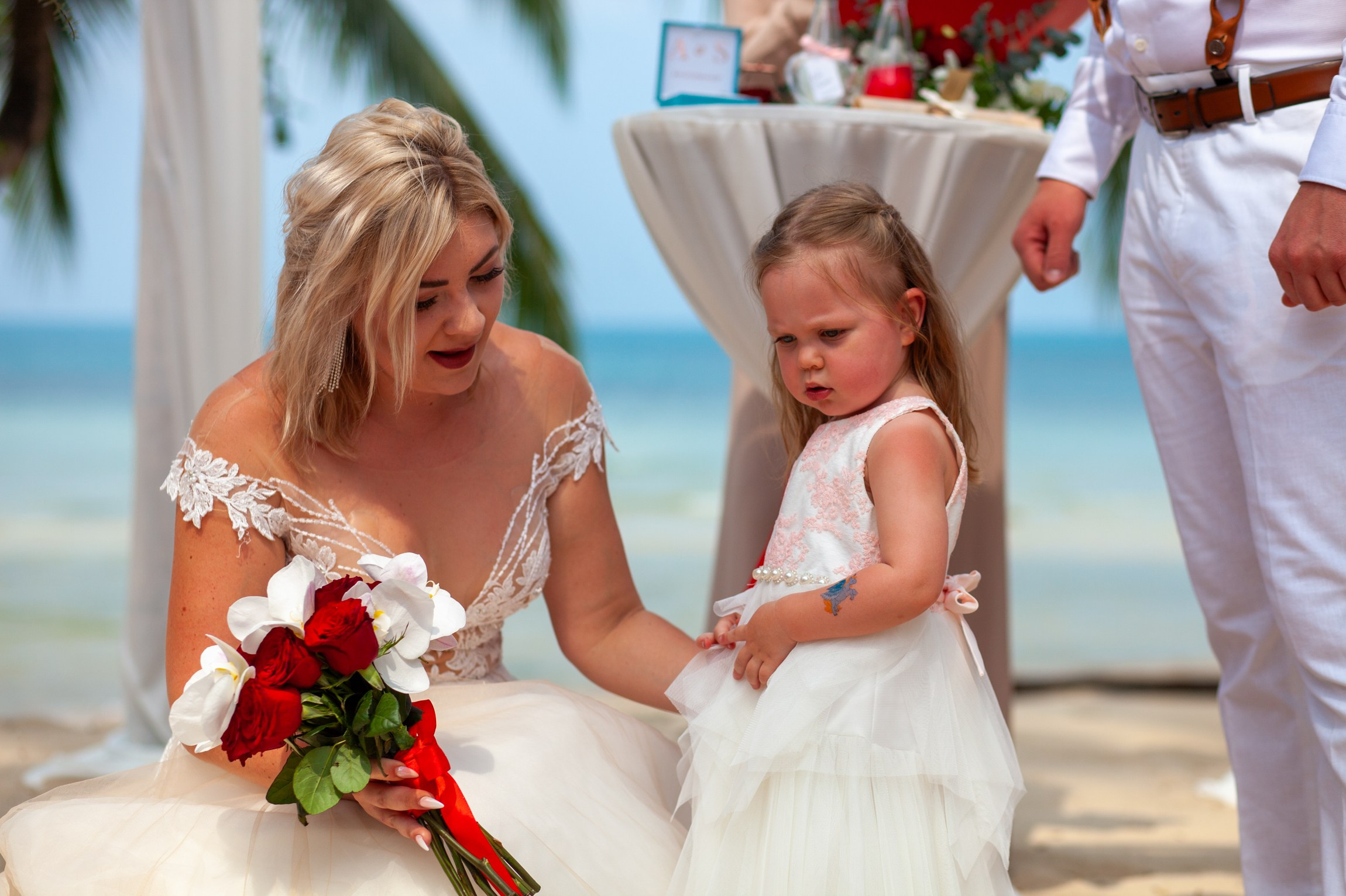 Elegant beach wedding setup on Koh Samui, Thailand with bride, groom, flowers and stunning sea backdrop