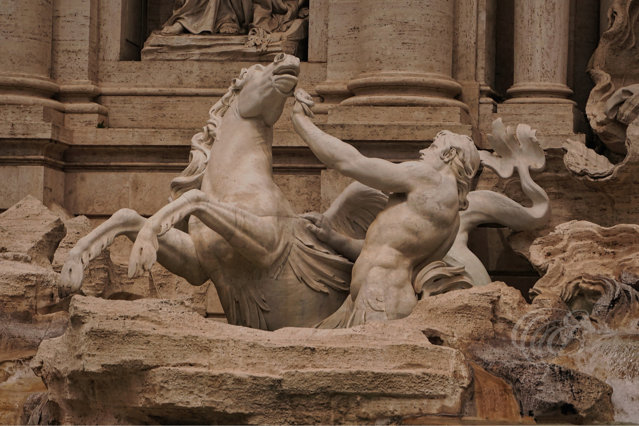 ITALY TRAVEL PHOTOGRAPHY – ITALY – ROME — Trevi Fountain Hippocampus & Triton — Sculptural detail of the Trevi Fountain showing mythological sea horse (hippocampus) and Triton figures within the Baroque fountain at Palazzo Poli, Rome, Italy — Eduardo Bartoli Photography.
