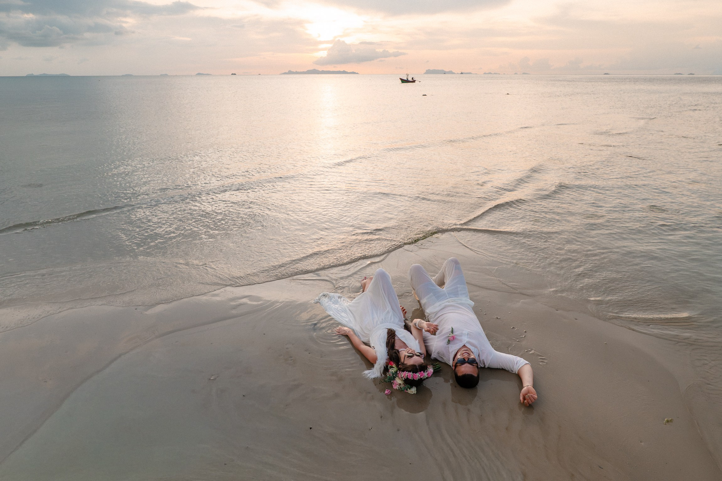 Bride and groom exchanging vows on a private sunset beach