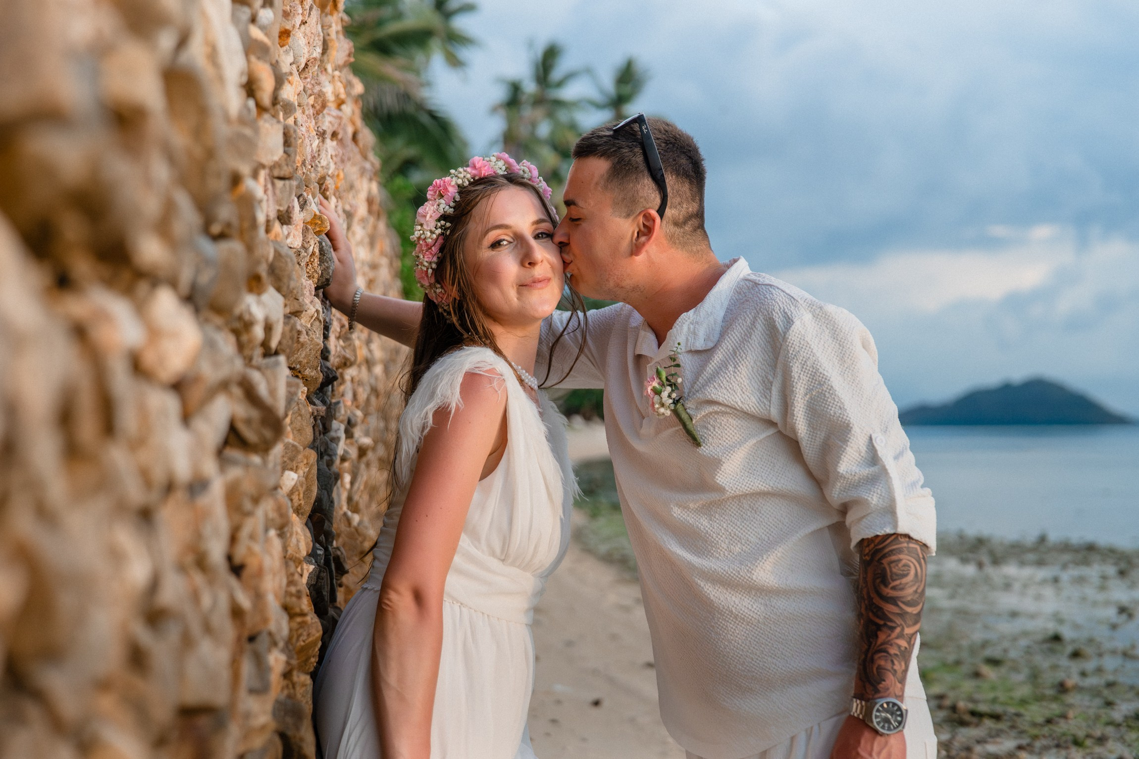 Bride and groom exchanging vows on a private sunset beach