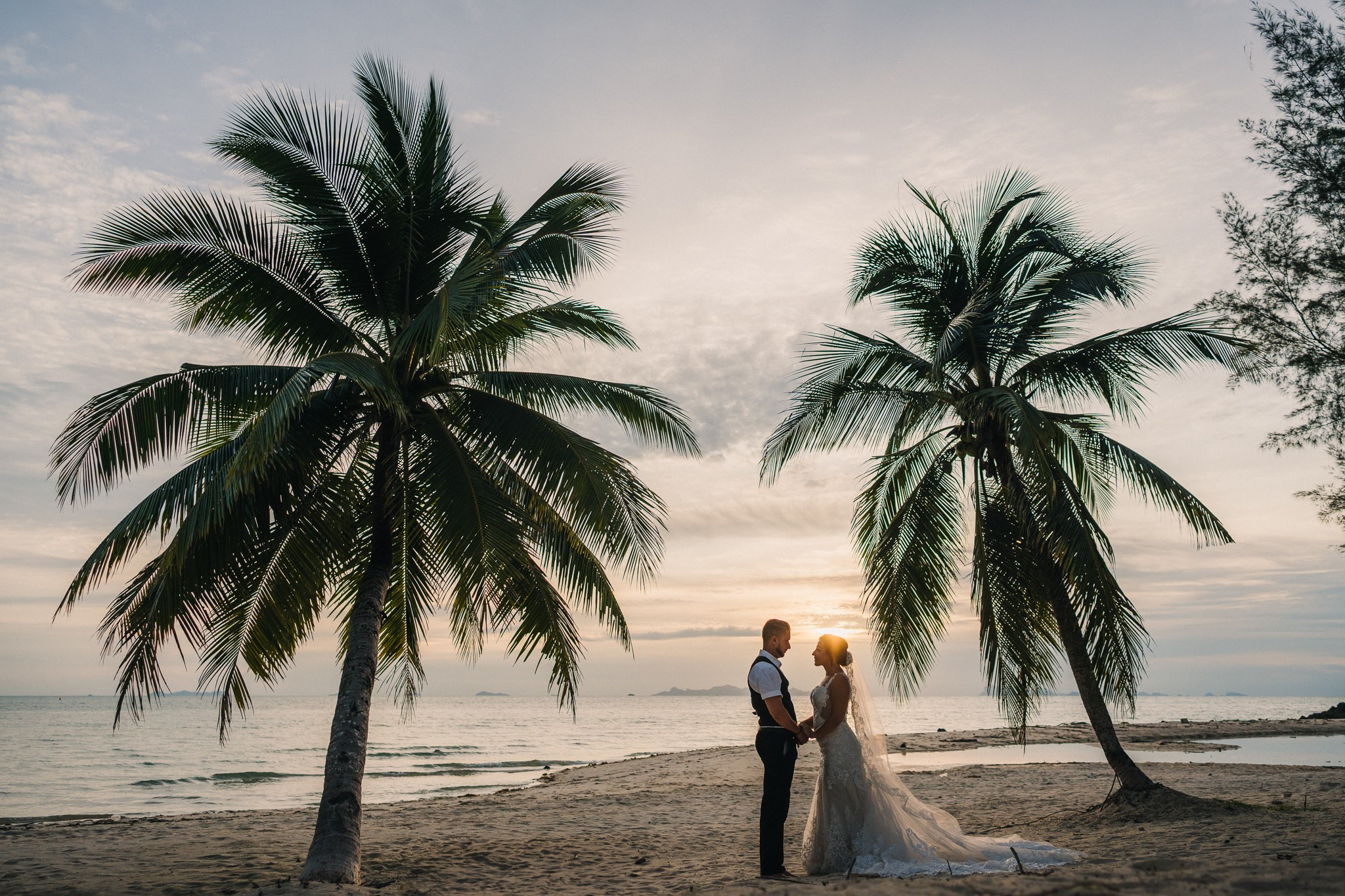 Romantic escape wedding in Koh Samui, Thailand with bride, groom and children on a beautiful tropical beach
