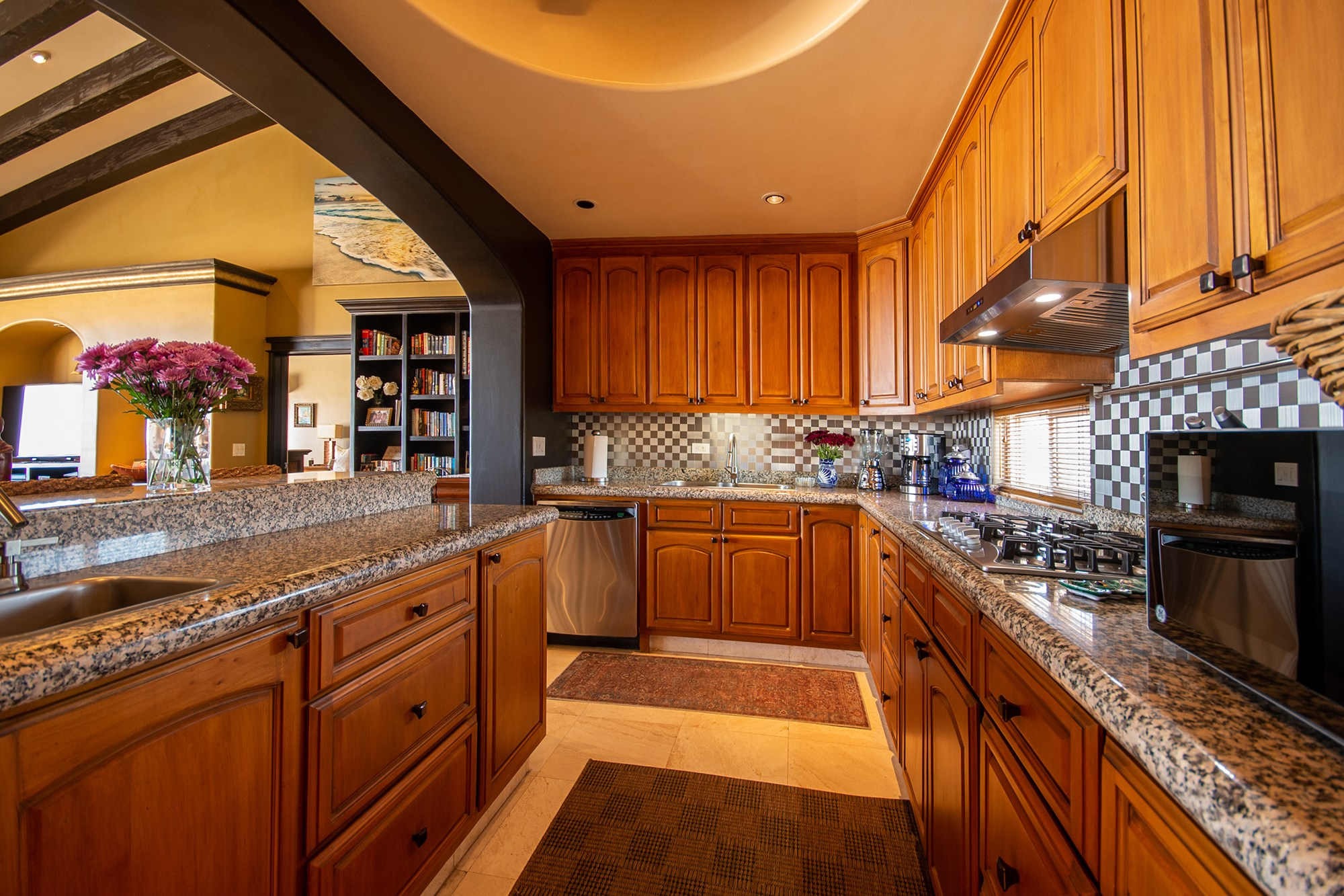 Warm tone kitchen interior in Los Cabos – wooden cabinets, arch details and open concept design, Baja California Sur real estate photography