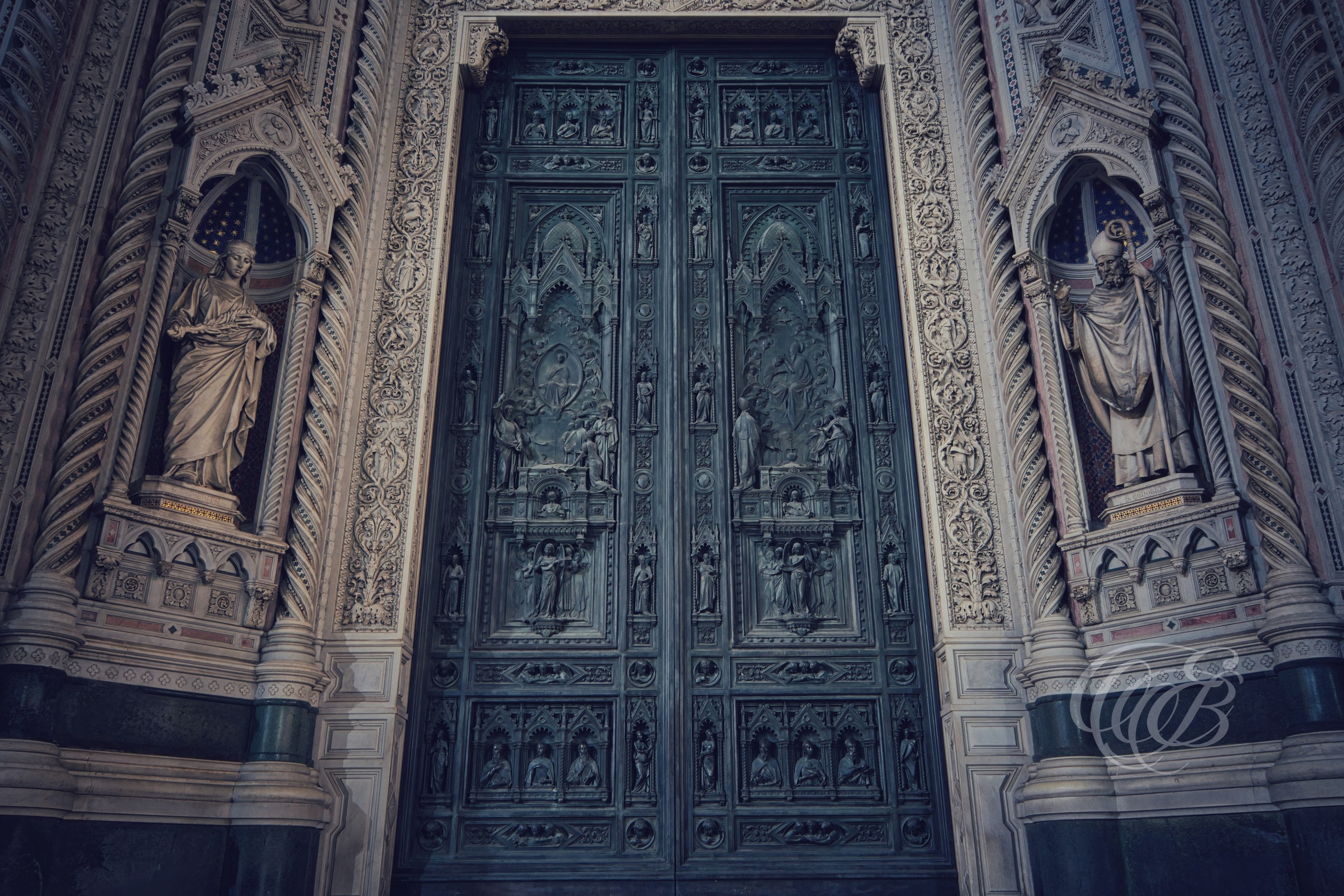 Florence, Italy – Cathedral bronze doors of Santa Maria del Fiore with detailed relief panels depicting biblical scenes, Renaissance architectural detail at Florence Cathedral – Eduardo Bartoli Photography.