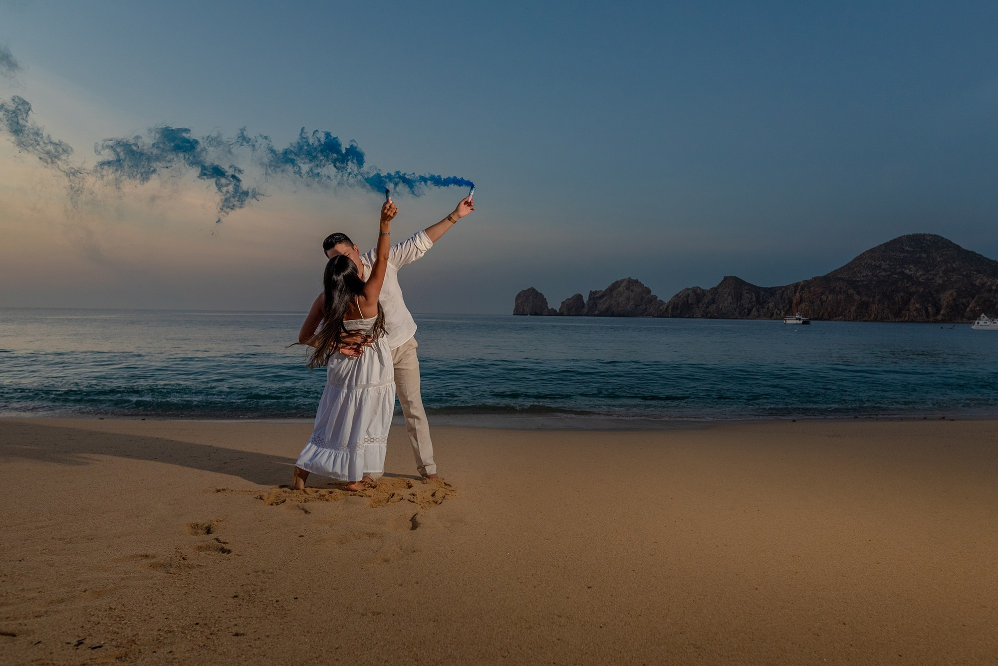 Maternity photoshoot in Los Cabos – pregnant mother on the beach embracing her baby bump, capturing the love and magic of new life by the ocean