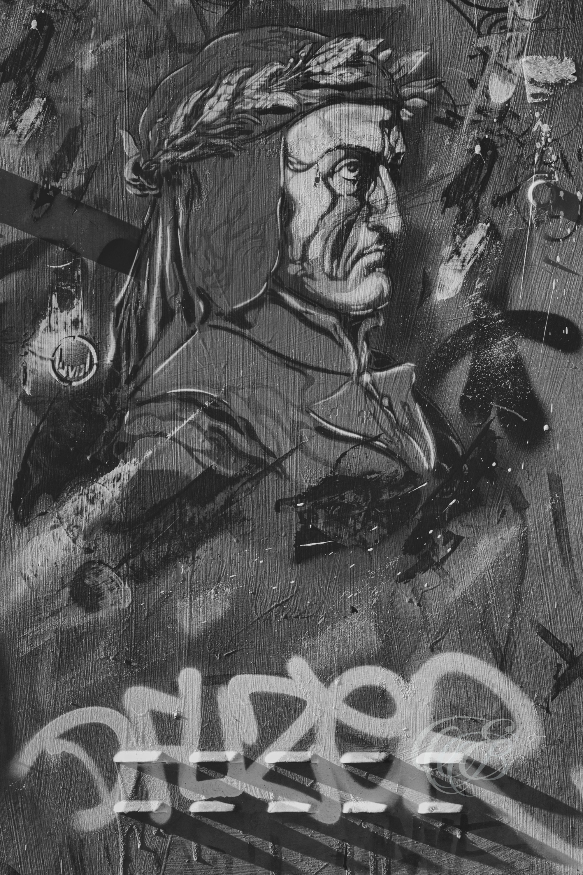 ITALY – FLORENCE — Dante Alighieri Graffiti Street Art Black and White — Urban mural of Dante Alighieri, author of Divine Comedy, depicted in contemporary graffiti style on city wall, blending modern street art with historical Florentine cultural heritage, Florence, Italy — Eduardo Bartoli Photography.