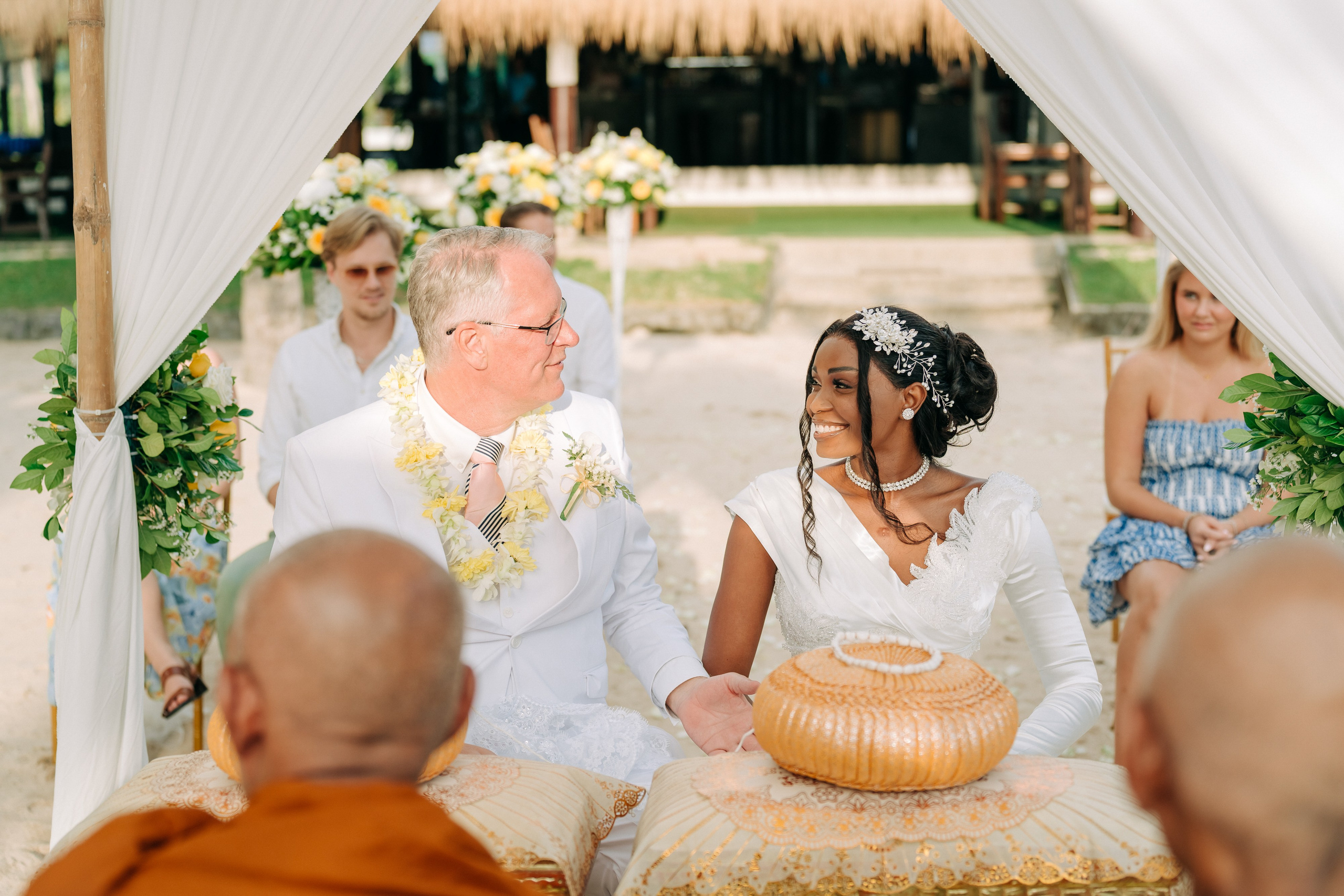 Couple celebrating a spiritual Buddhist wedding ceremony on Koh Samui