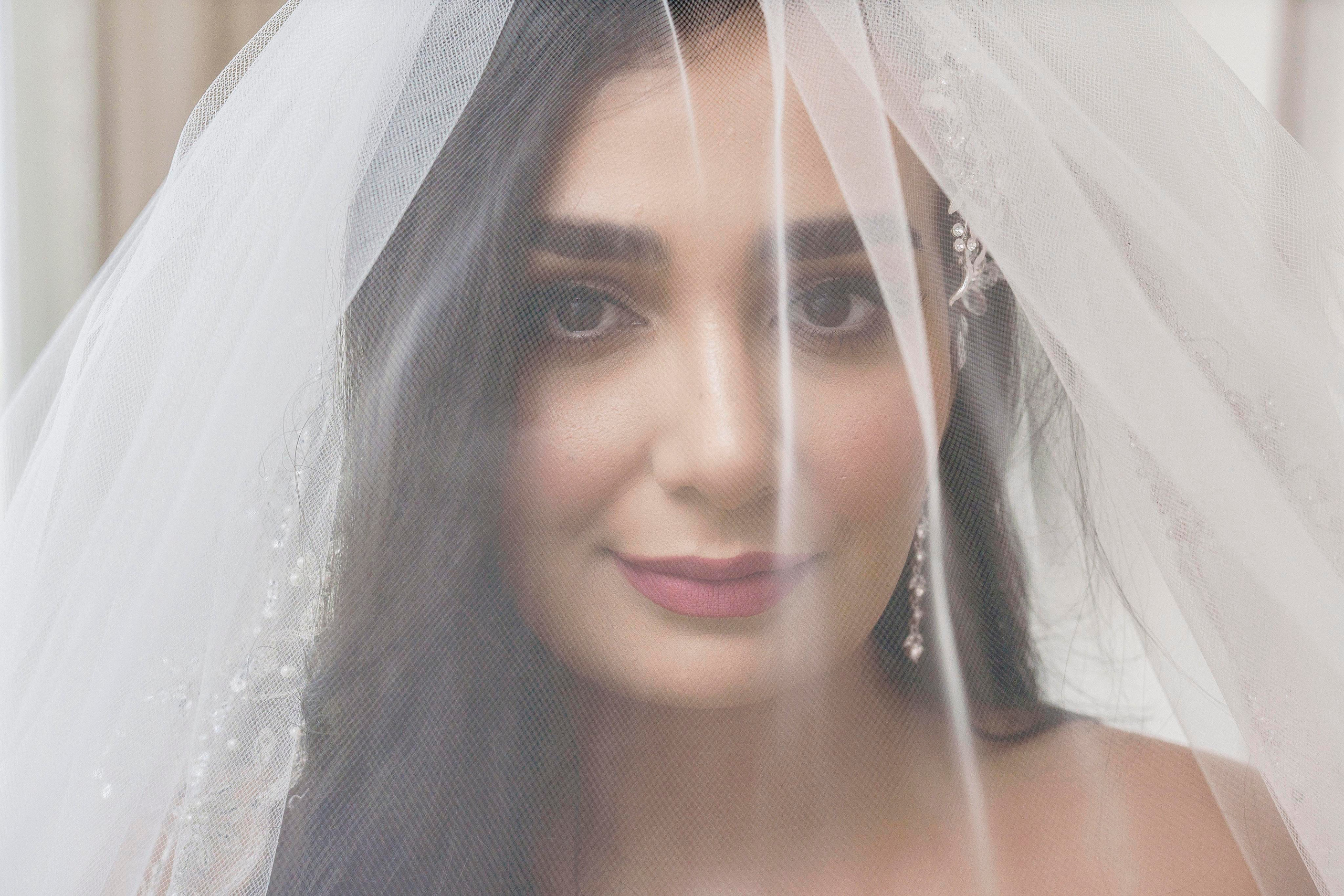 Bride in lace dress photographed during luxury getting ready session