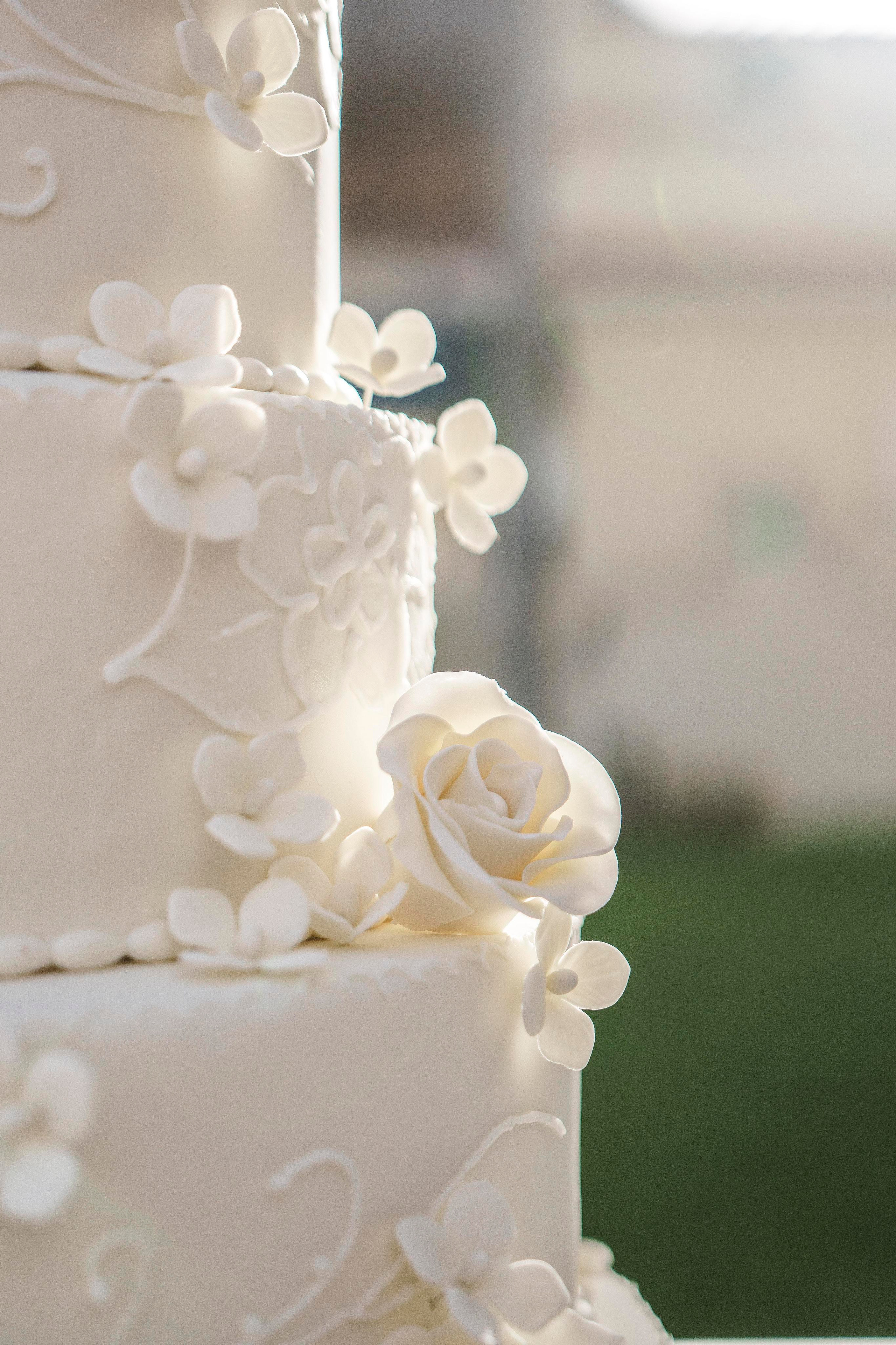 Destination wedding cake with white florals photographed in Mexico