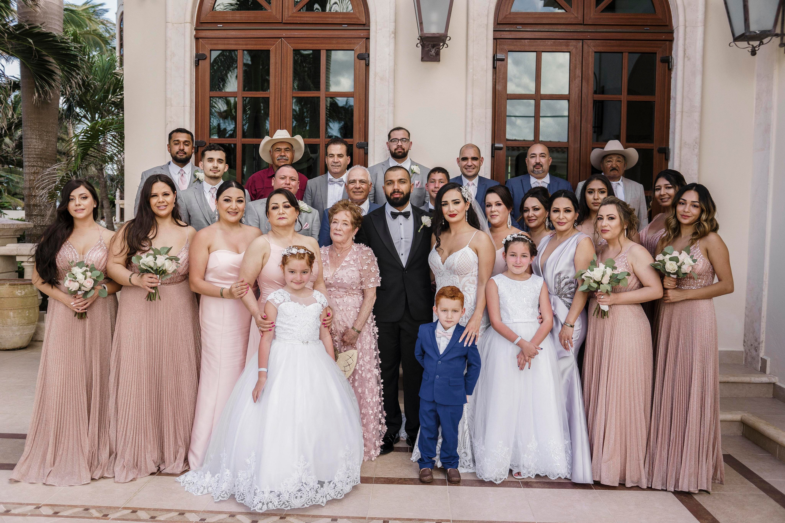 Full wedding group portrait in front of hacienda – captured in Riviera Maya