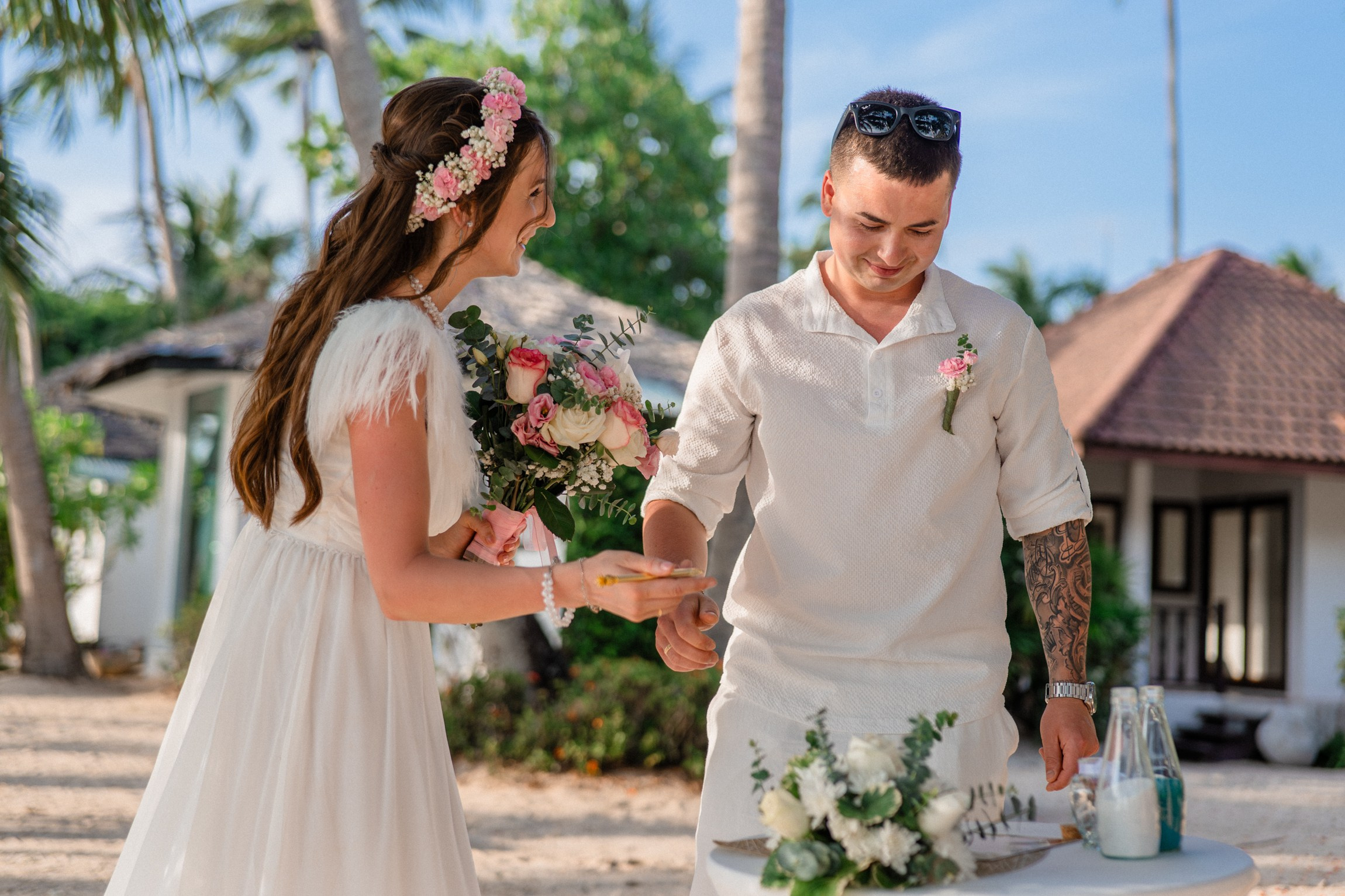 Bride and groom exchanging vows on a private sunset beach