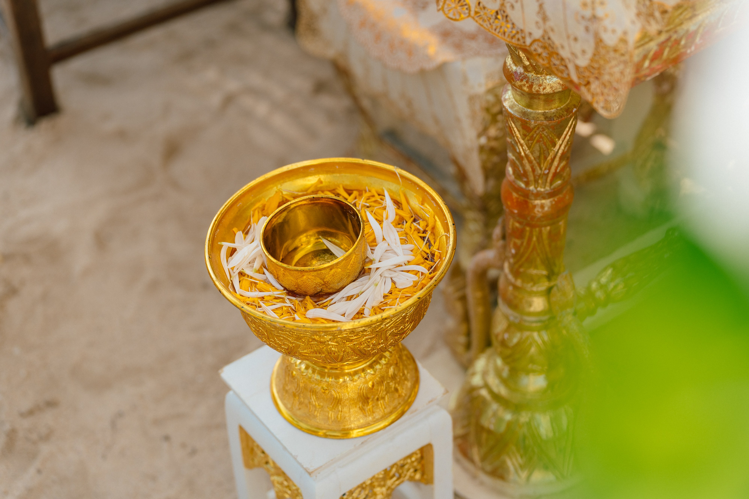 Couple taking part in a traditional Buddhist wedding ceremony on a tropical beach in Koh Samui, Thailand, with monks, flowers, and ocean views.