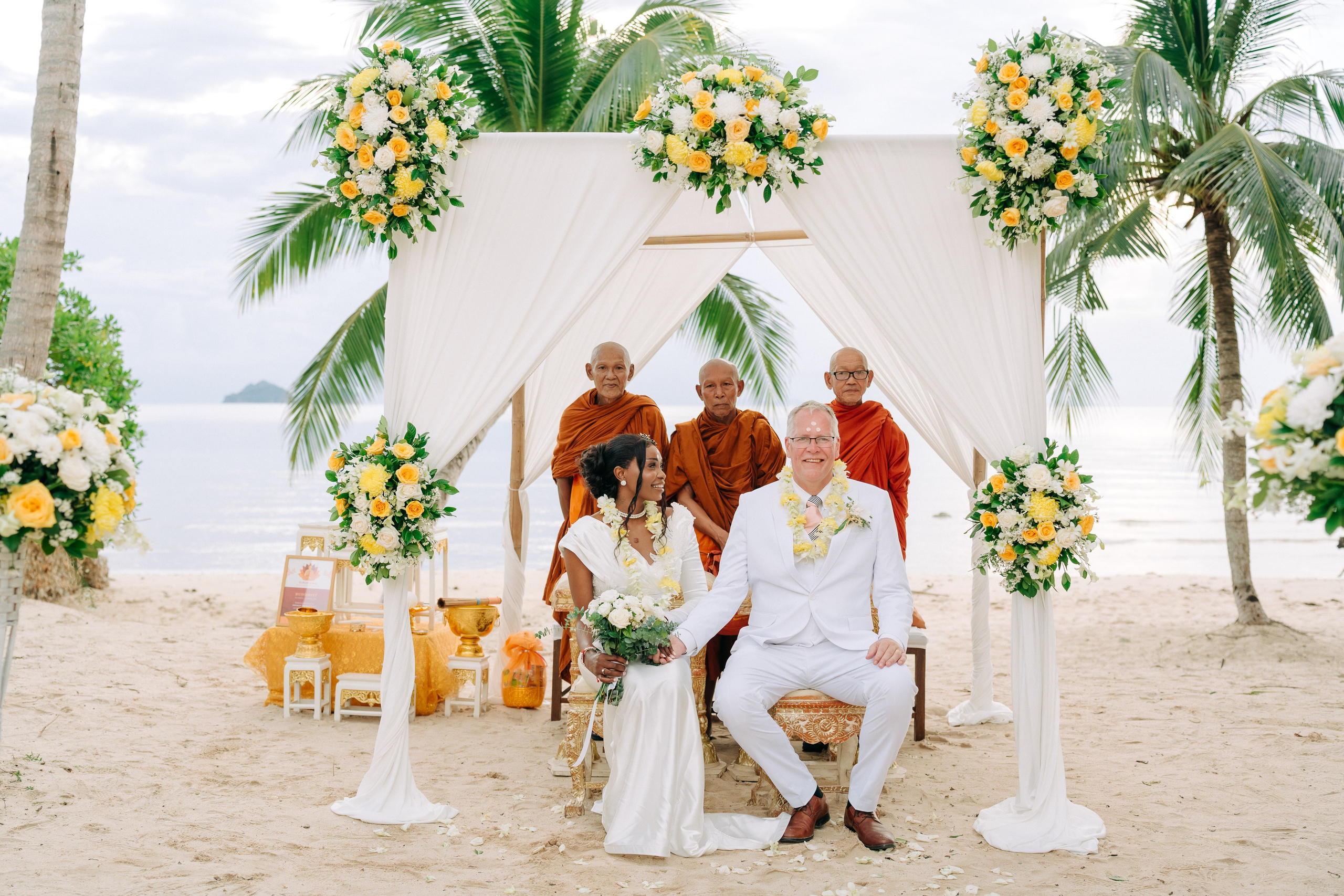 Couple celebrating a spiritual Buddhist wedding ceremony on Koh Samui