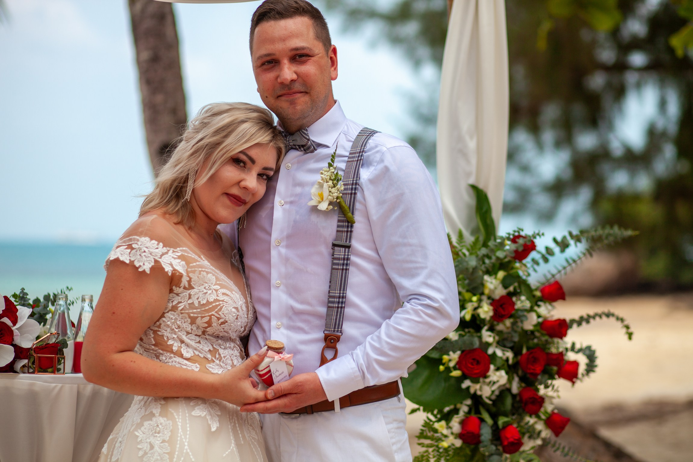Bride and groom during a romantic beach wedding ceremony on Koh Samui, Thailand, surrounded by tropical scenery and ocean views