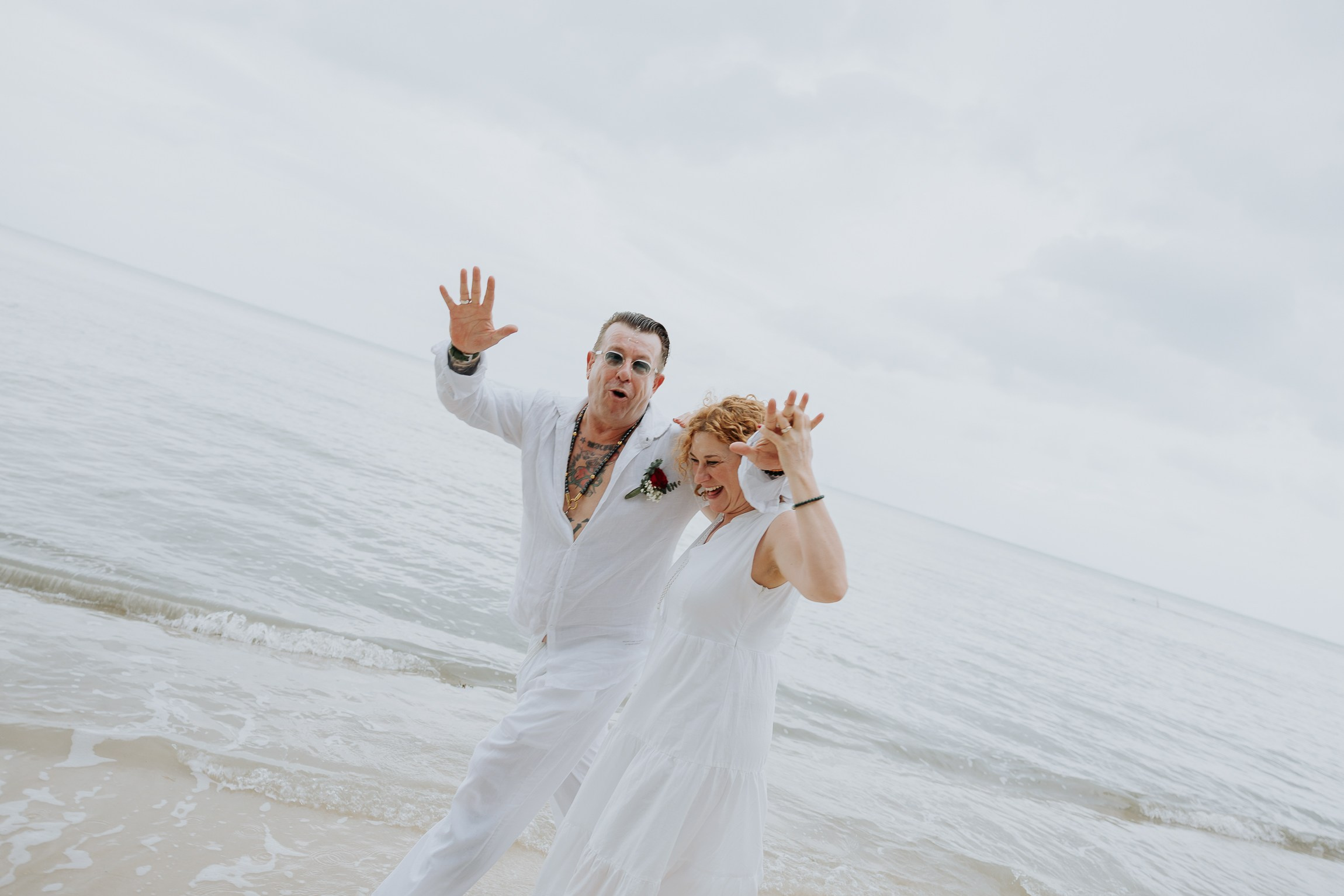 Couple with guests celebrating a spiritual Buddhist wedding ceremony on Koh Samui