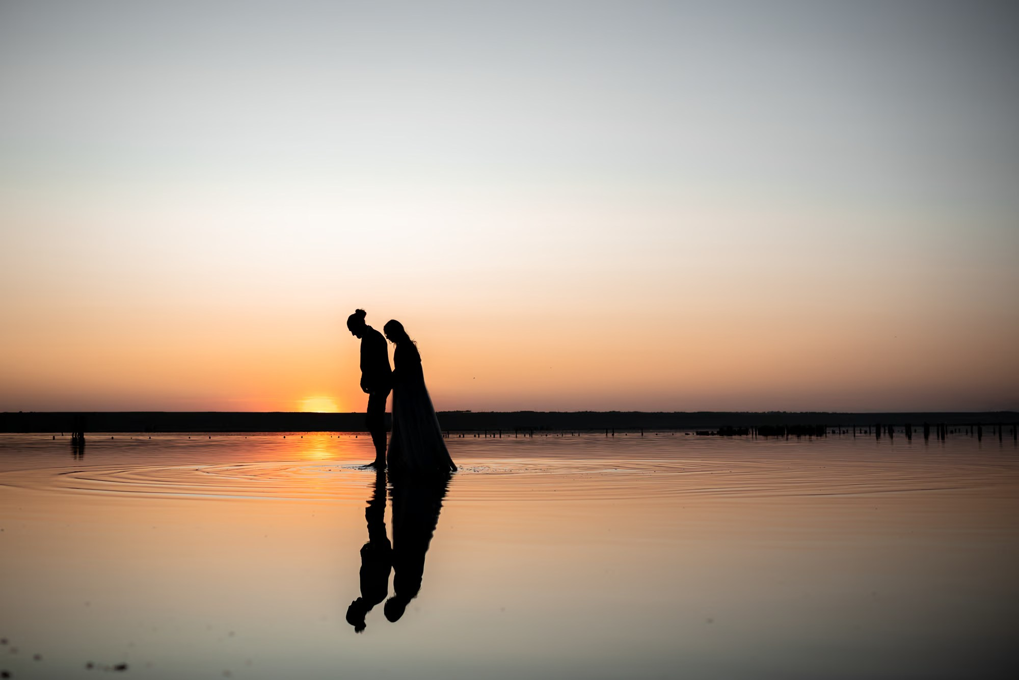 Romantic photoshoot Punta Cana with a couple walking along the tropical shoreline.