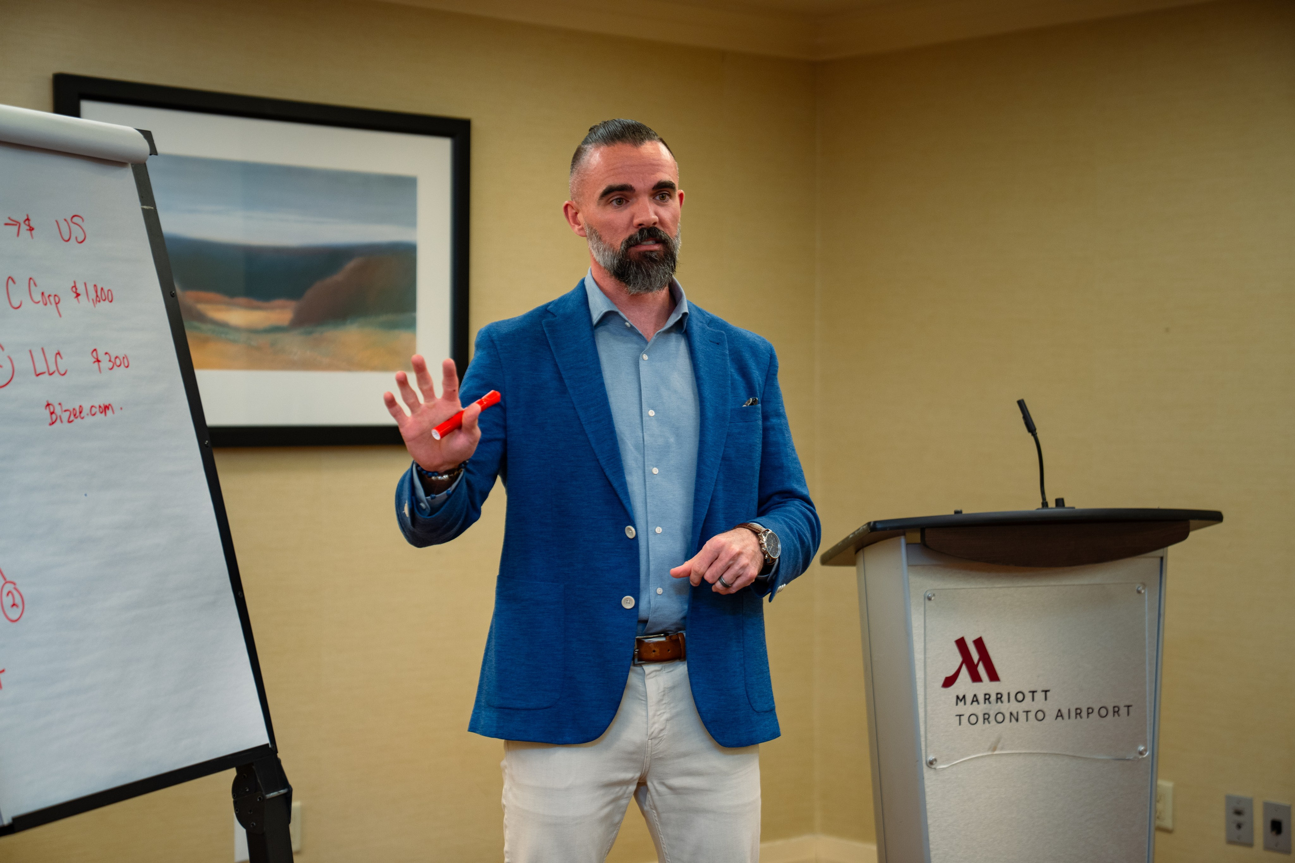 Matt Poechman presenting at podium during networking event