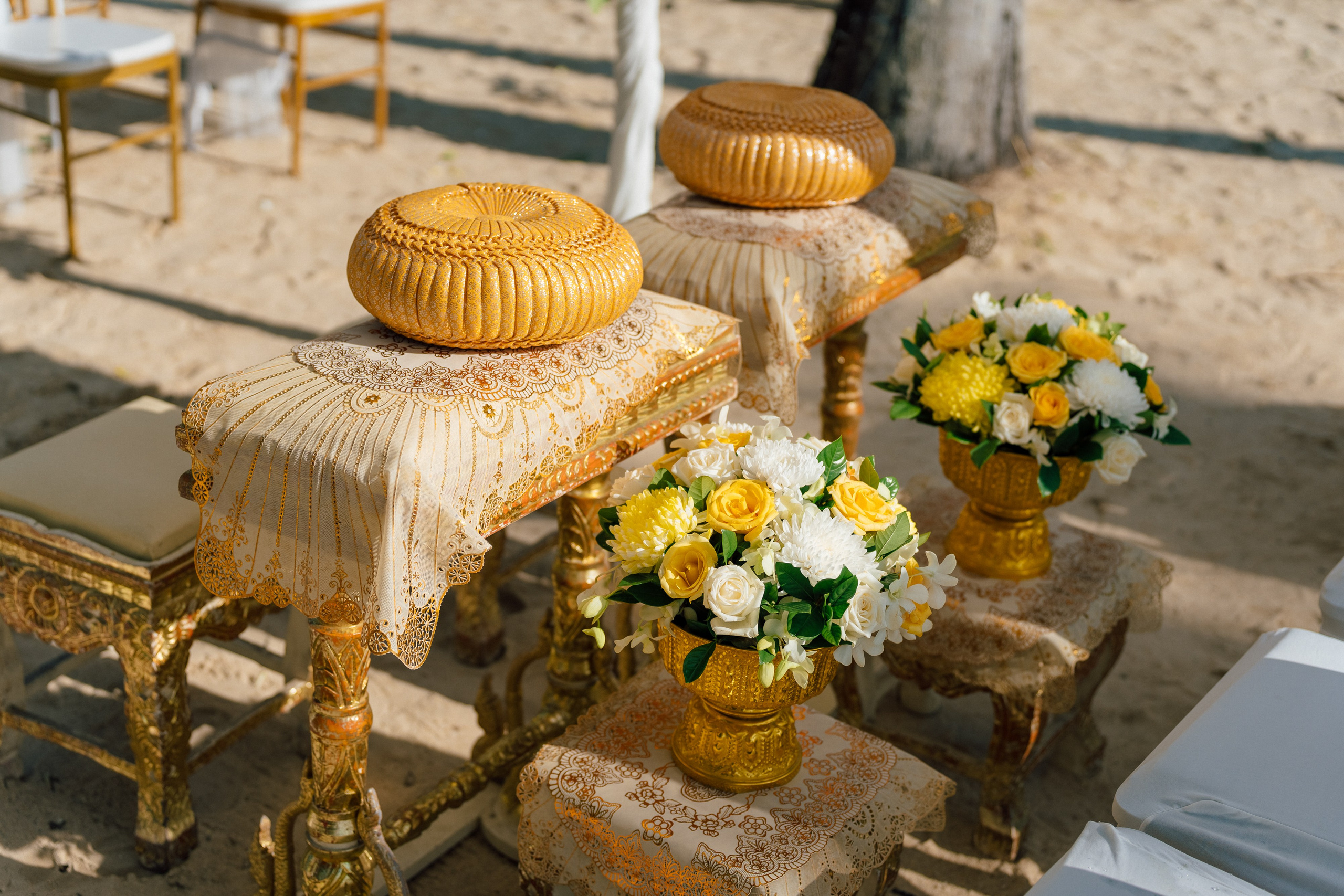 Bride and groom participating in a sacred Buddhist blessing ceremony by the sea in Koh Samui, Thailand.