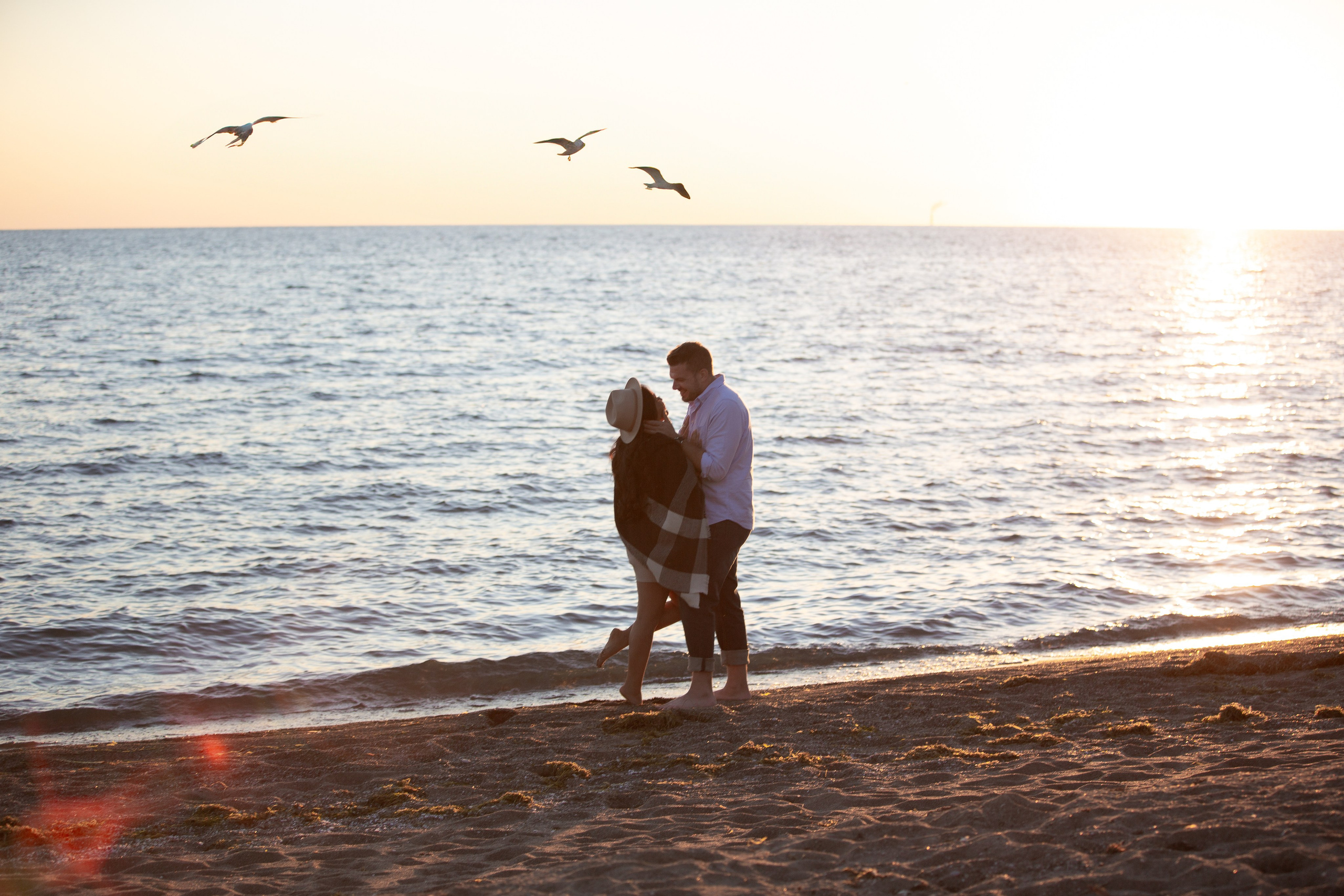Engaged couple at sunset at Colchester Beach in Essex County, Ontario